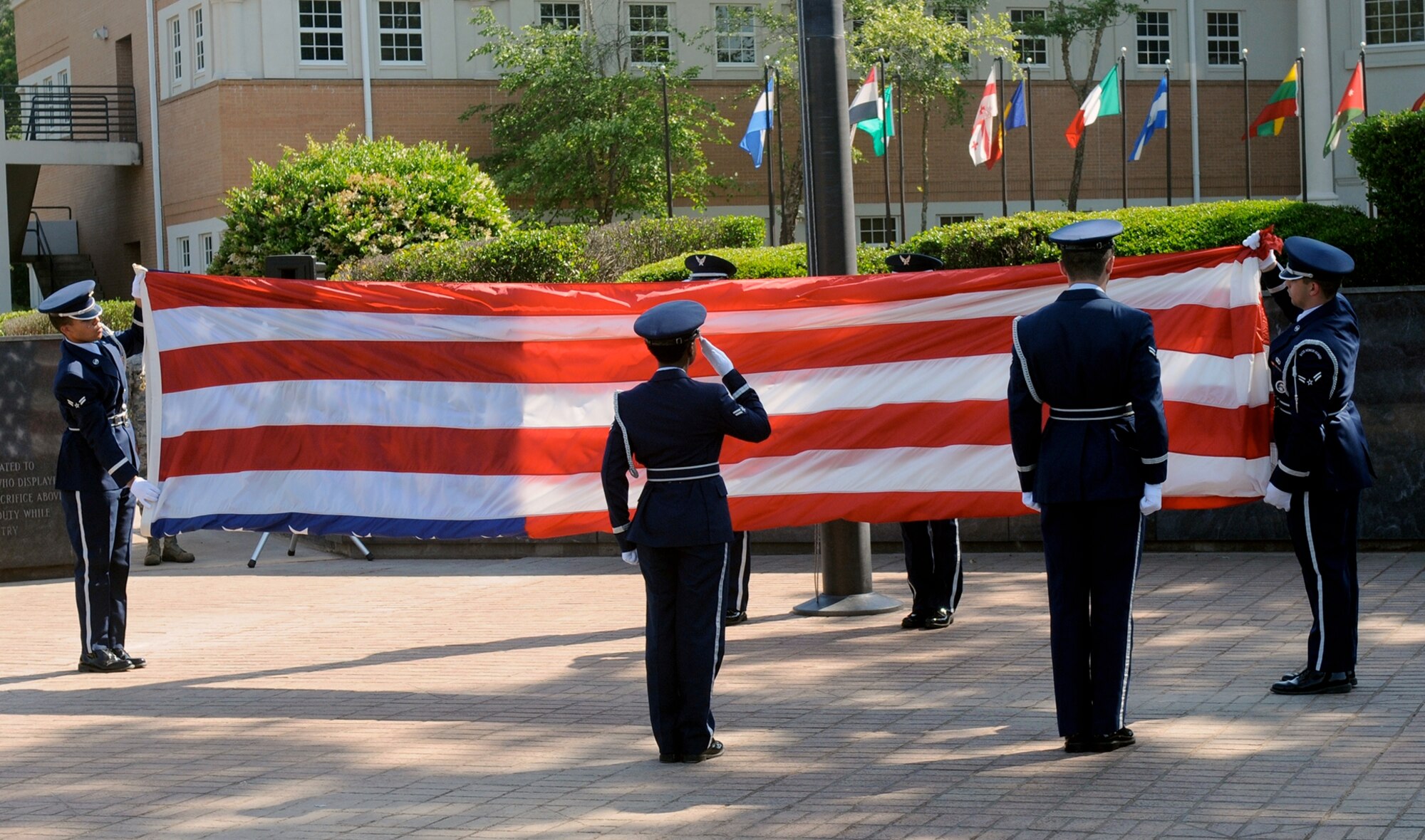 Columbus Air Force Base Honor Guard Airmen fold the U.S. flag during a Memorial Day retreat ceremony on base, May 22. Memorial Day, not to be confused with Veterans Day, is a day of remembering the men and women who died while serving. Veterans Day celebrates the service of all U.S. military veterans. (U.S. Air Force photo/ Sharon Ybarra)