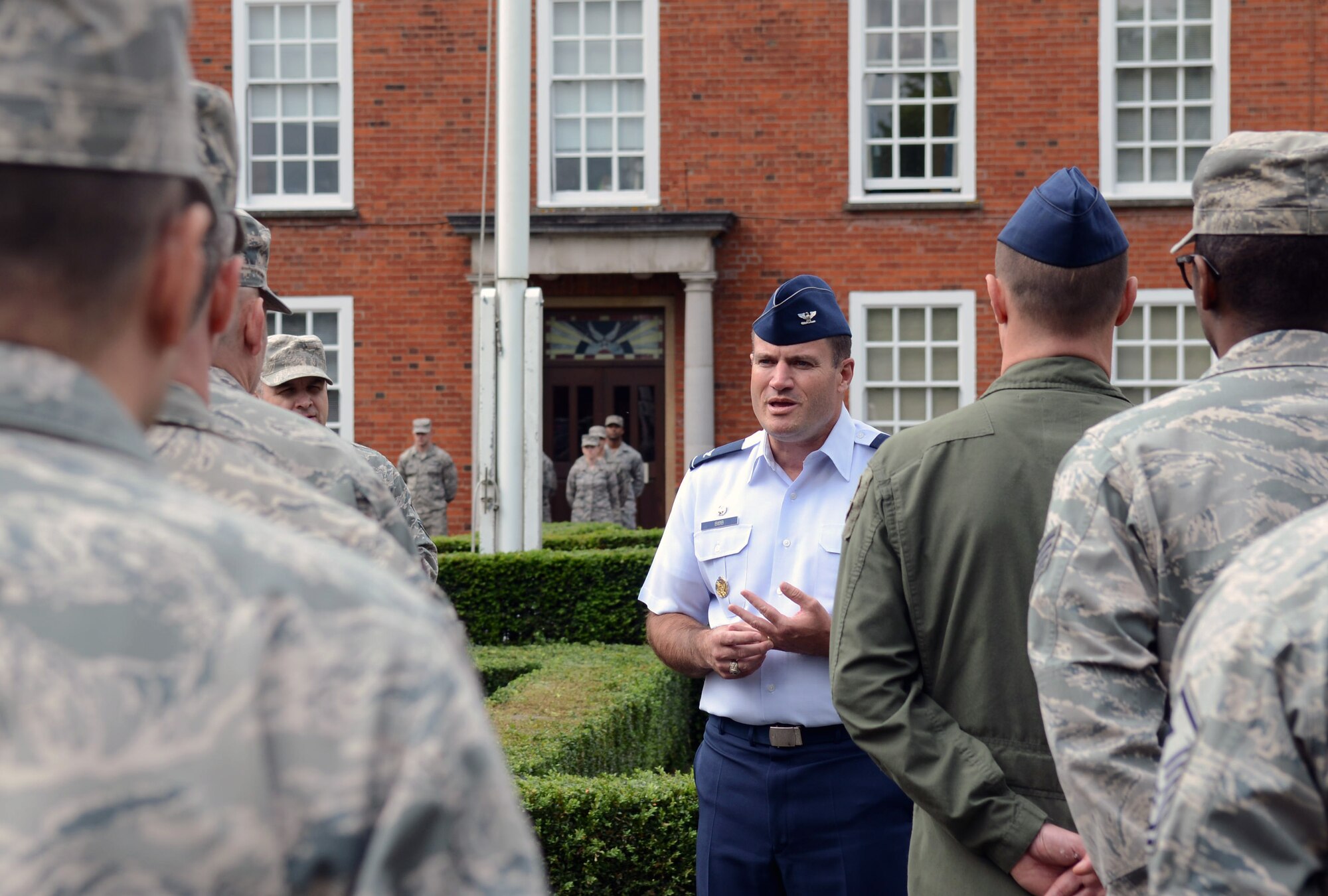 U.S. Air Force Col. Kenneth T. Bibb Jr., 100th Air Refueling Wing commander, speaks to Airmen participating in a retreat ceremony May 30, 2014, on RAF Mildenhall, England. Retreat is a long-standing tradition honoring the flag and signaling the end of the duty day. (U.S. Air Force photo/Airman 1st Class Kyla Gifford/Released)