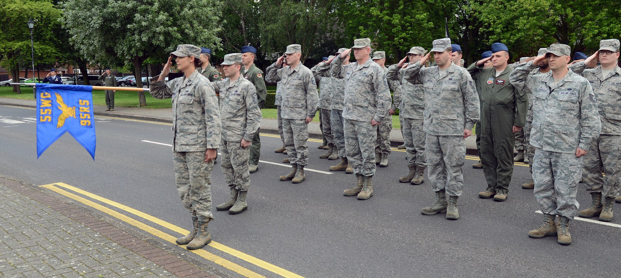 U.S. Air Force Capt. Lindsay Christopherson, 95th Reconnaissance Squadron maintenance operations officer, salutes the U.S. flag as it’s lowered during the monthly retreat ceremony May 30, 2014, on RAF Mildenhall, England. Retreat is a long-standing tradition honoring the flag and signaling the end of the duty day. (U.S. Air Force photo/Airman 1st Class Kyla Gifford/Released)