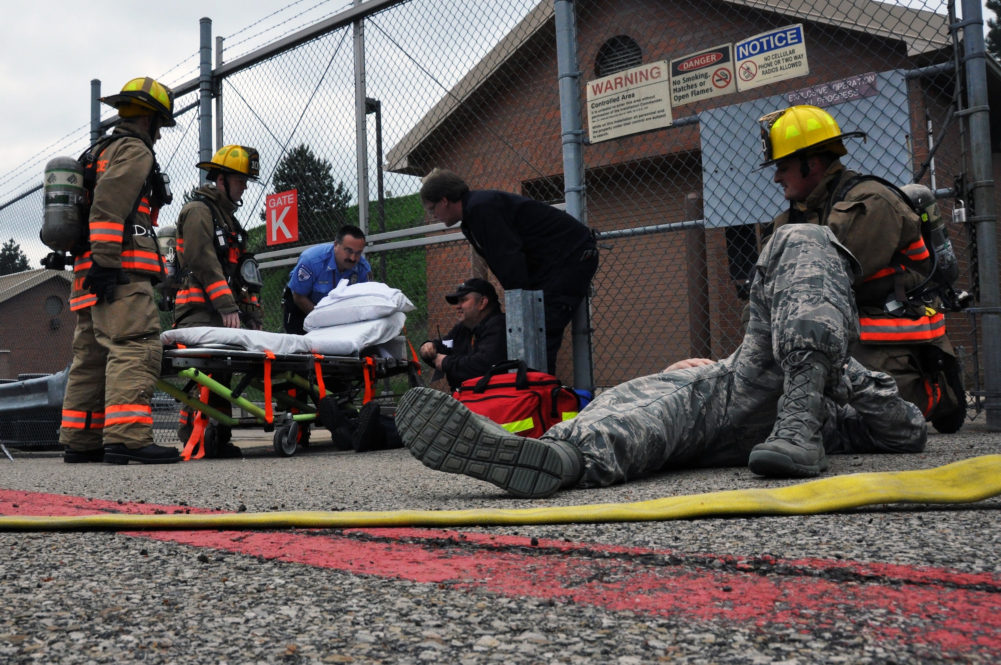 Civilian emergency responders assist and tend to members of the 911th Airlift Wing as part of a munitions fire exercise at the Pittsburgh International Airport Air Reserve Station, May 16, 2014. This exercise focused on the cooperation and coordination between 911th Security Forces Squadron members and civilian emergency responders as part of the new Commander’s Inspection Program. (U.S. Air Force photo by Senior Airman Marjorie A. Bowlden)
