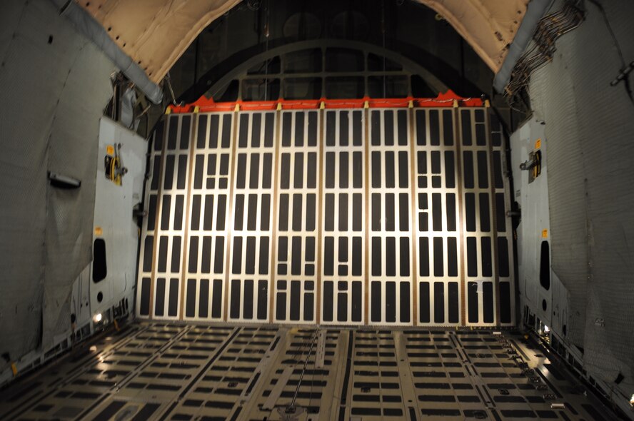 The rear loading doors of the C-5C Space Cargo Modified Galaxy has been retrofitted for the Space Container Transportation System. The SCTS is specifically designed for the C-model. Loading and unloading the canister requires very slow and precise movements accomplished by the teamwork of six loadmasters. (U.S. Air Force photo/ Staff Sgt. Christopher Carranza)