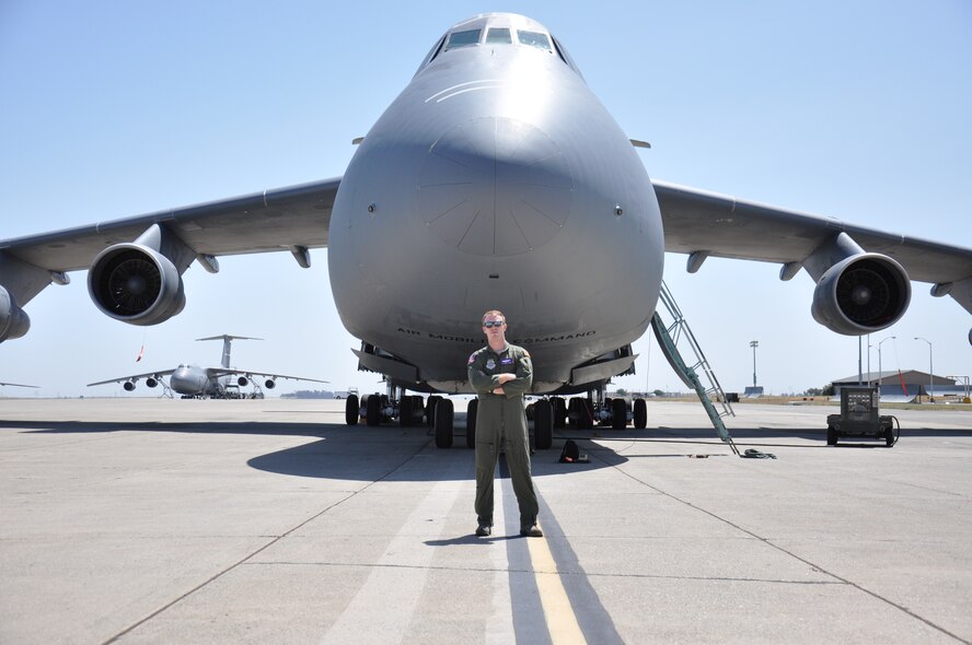 Staff Sgt. Will Harden, 22nd Airlift Squadron evaluator loadmaster, stands in front a C-5C Space Cargo Modified Galaxy May 28 at Travis. The first flying mission of the C-5C was the transportation of the Hubble Space Telescope and now is scheduled to transport components of the James Webb Space Telescope, which is slated to replace Hubble in the future. (U.S. Air Force photo/ Staff Sgt. Christopher Carranza)