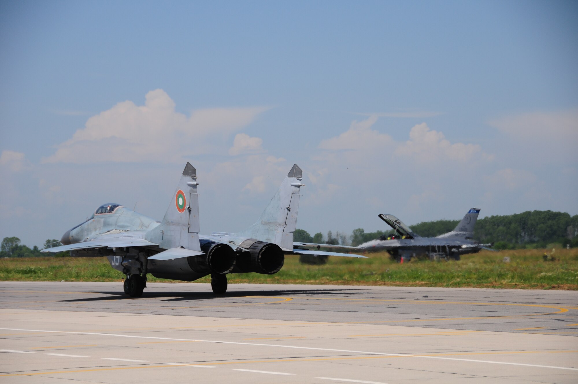 A Bulgarian MiG-29 taxis in front of a 148th Fighter Wing, Minnesota Air National Guard F-16 during Thracian Star 2014. The event is a yearly Bulgarian exercise that has been held since 2005. (U.S. Air Force photo/ Capt. Jodi Kiminski)