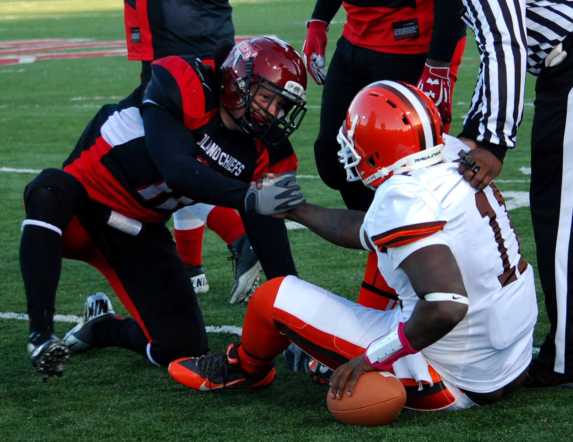 Senior Airman Cody Walter, 60th Medical Support Squadron medical logistics technician, helps an opposing player up after the play. Walters plays for Solano Chiefs as a middle linebacker, punter and field goal kicker. (Photo by Sandra Eaton)