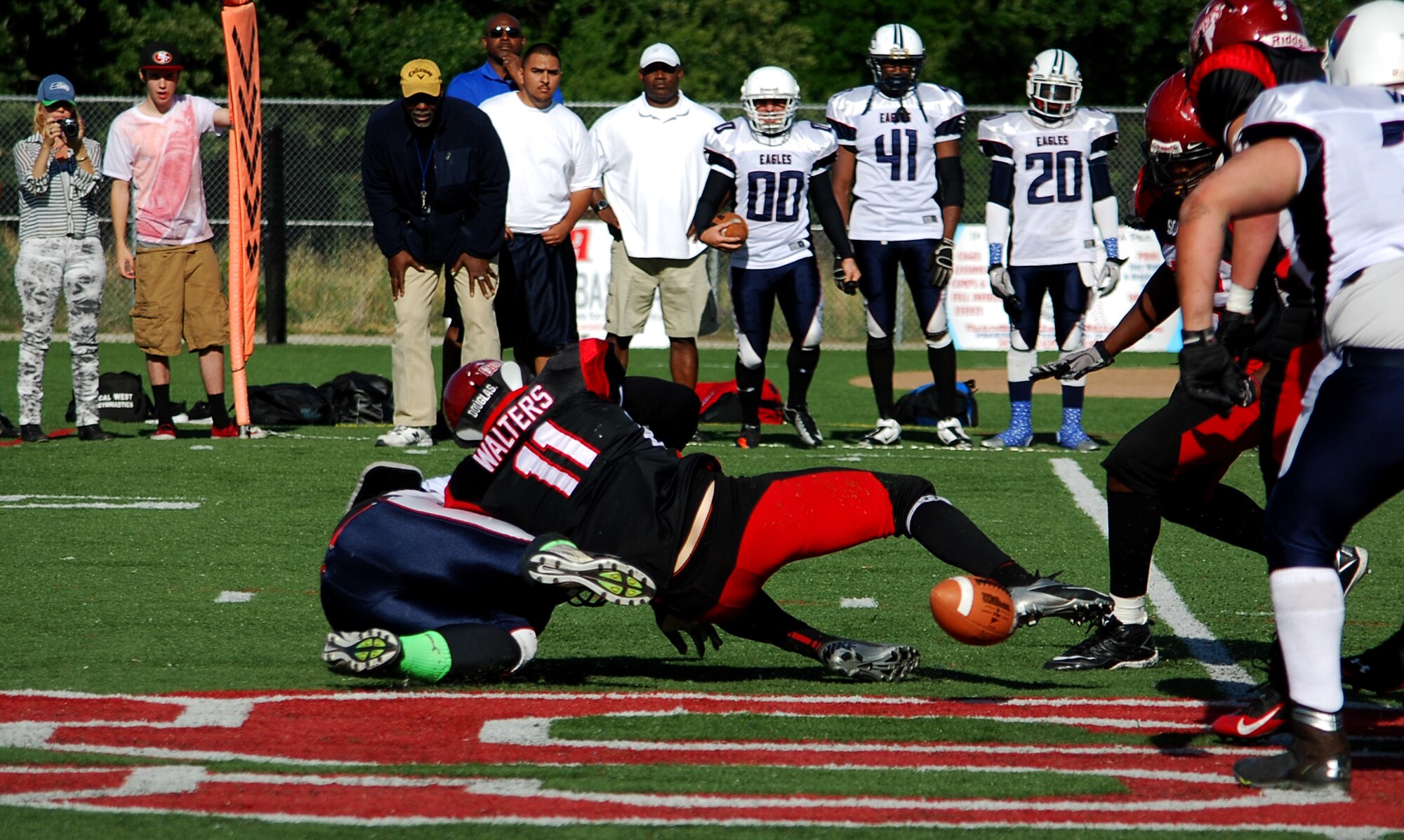 Senior Airman Cody Walters, 60th Medical Support Squadron medical logistics technician, forces a fumble against the San Jose Eagles May 10, 2014, resulting in a 24-21 win. Walters serves as the Solano Chiefs leading tackler and defensive captain. (Photo by Sandra Eaton)