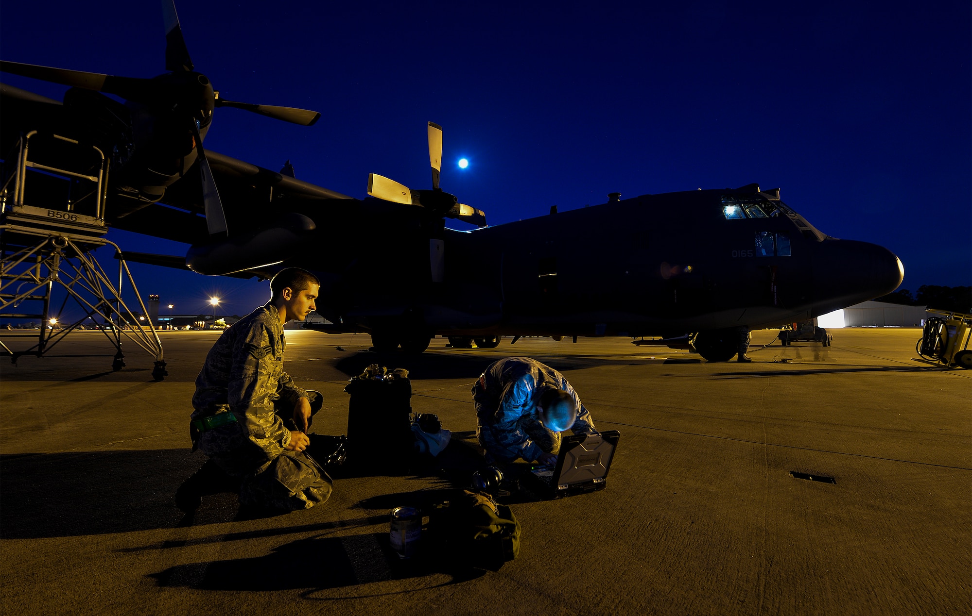 Senior Airman Christopher Hawkins and Airman 1st Class Eric Campbell, Aircraft Maintenance Unit aerospace propulsion journeymen, review technical orders before performing maintenance on an AC-130U Spooky Gunship at Hurlburt Field, Fla., May 16, 2014. The 4th AMU helps generate nearly 20 training mission flights each week. (U.S. Air Force photo/Senior Airman Christopher Callaway) 