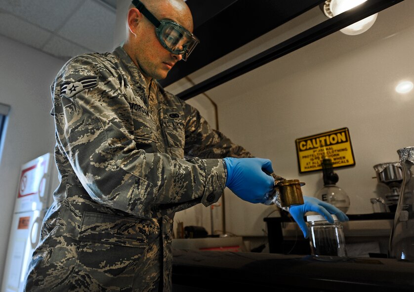 Senior Airman Johnathan Morgan, 1st Special Operations Logistics Readiness Squadron fuels journeyman, checks fuel for quality at Hurlburt Field, Fla., May 20, 2014. The petroleum, oils and lubricants flight is responsible for testing the fuel they receive before distributing it throughout the base. (U.S. Air Force photo/Staff Sgt. Jeff Andrejcik)