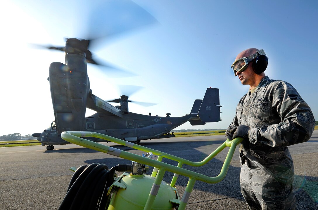 Senior Airman Johnathan Morgan, 1st Special Operations Logistics Readiness Squadron fuels journeyman, stands by with a halon fire extinguisher on the flightline at Hurlburt Field, Fla., May 20, 2014. The fire extinguisher is used in the event of an emergency with the aircraft. (U.S. Air Force photo/Staff Sgt. Jeff Andrejcik)