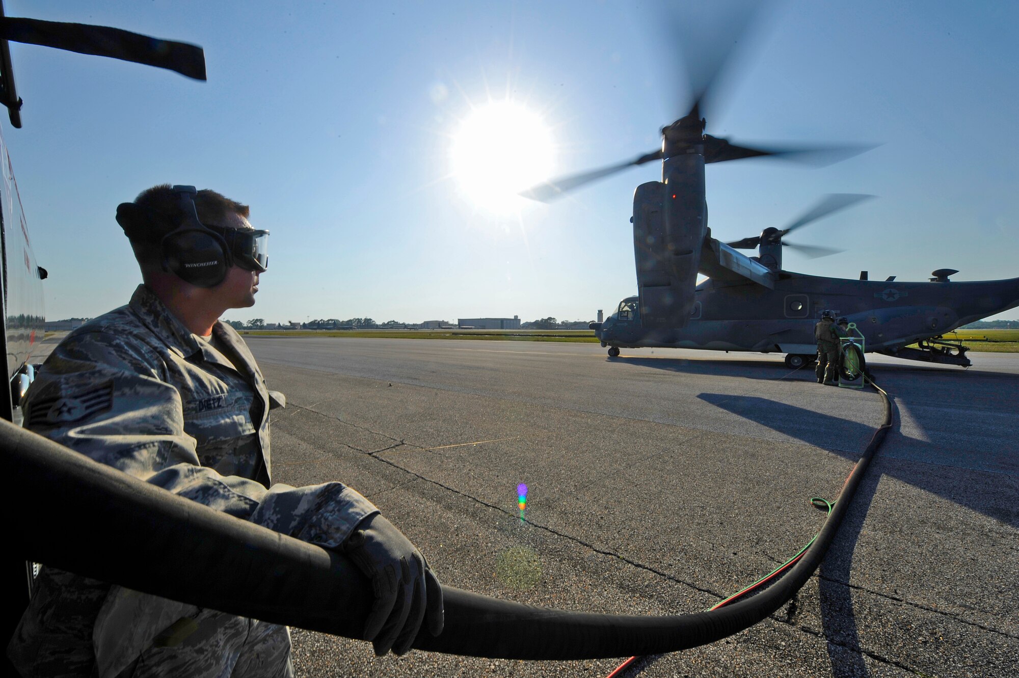 Staff Sgt. Michael Dietz, 1st Special Operations Logistics Readiness Squadron fuels craftsman, assists CV-22 Osprey crew chiefs with refueling their aircraft at Hurlburt Field, Fla., May 20, 2014. The Osprey was being refueled for a training mission. (U.S. Air Force photo/Staff Sgt. Jeff Andrejcik)