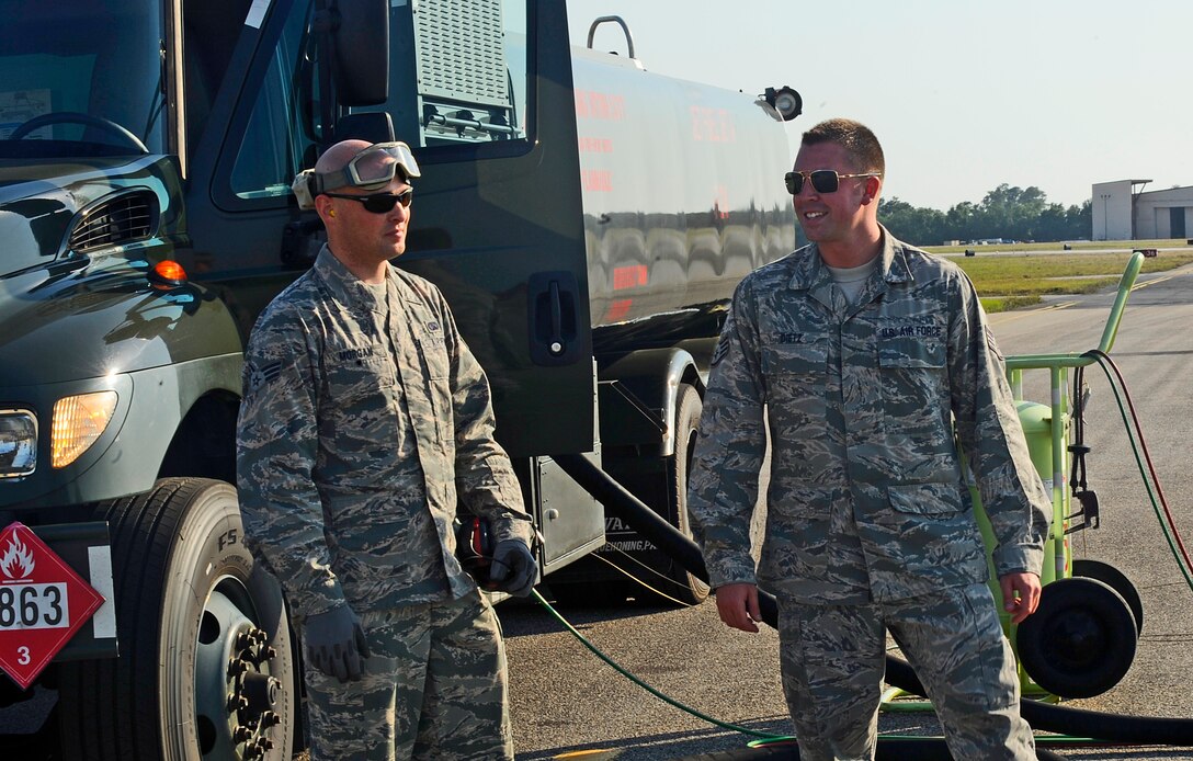 Senior Airman Johnathan Morgan, 1st Special Operations Logistics Readiness Squadron fuels journeyman, left, and Staff Sgt. Michael Dietz, 1st SOLRS fuels craftsman, wait to refuel a CV-22 Osprey at Hurlburt Field, Fla., May 20, 2014. The Petroleum, Oils and Lubricants flight is responsible for transporting and dispensing thousands of gallons of fuel weekly at Hurlburt Field. (U.S. Air Force photo/Staff Sgt. Jeff Andrejcik)