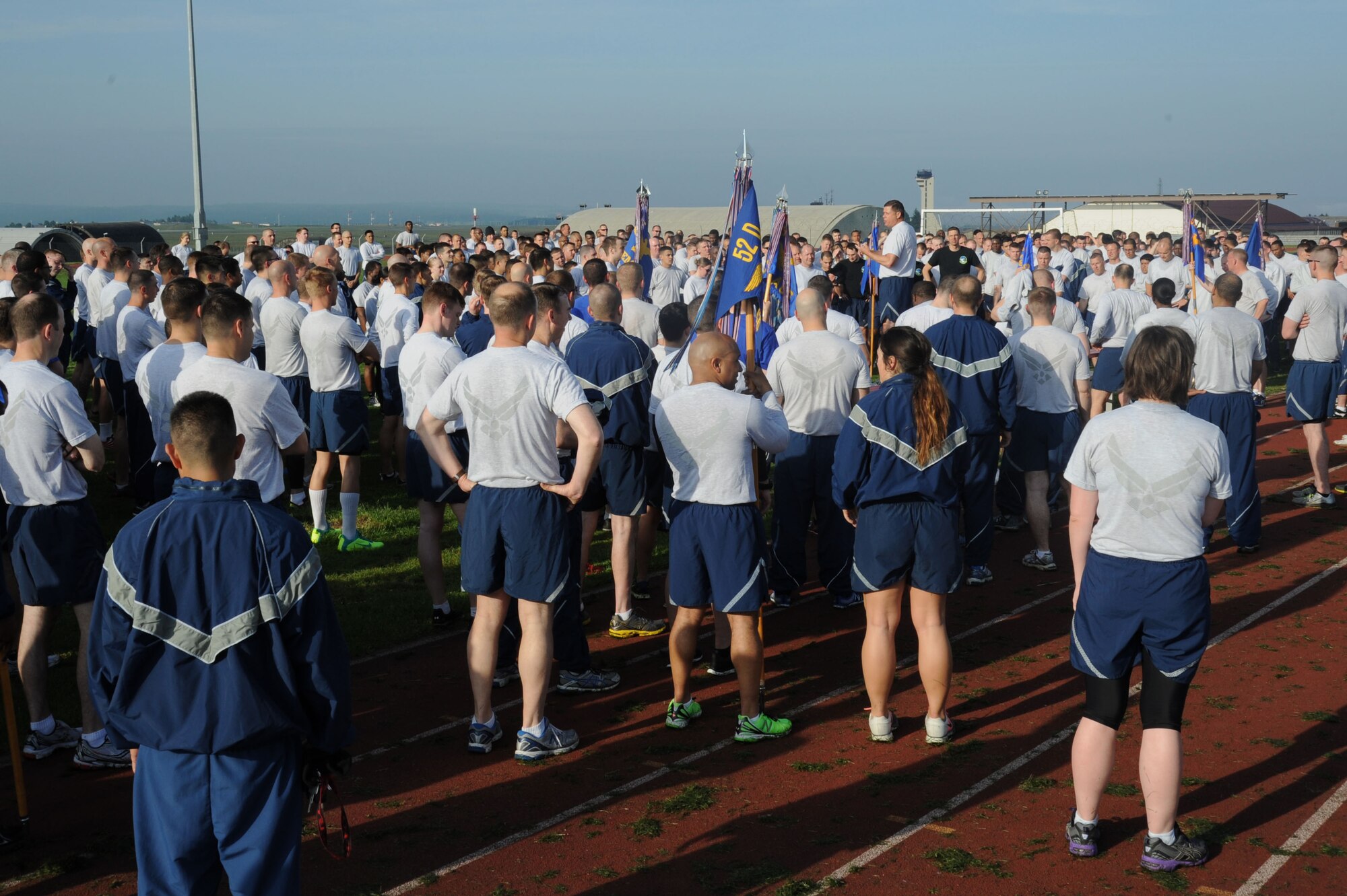 U.S. Air Force Airmen from the 52nd Fighter Wing listen to Chief Master Sgt. Chad Ward, acting 52nd Fighter Wing command chief speak after a wing wide run during sports day May 29, 2014, at Spangdahlem Air Base, Germany. Squadrons competed in seven sports in an effort to claim the first-place title. (U.S. Air Force photo by Airman 1st Class Dylan Nuckolls/Released)