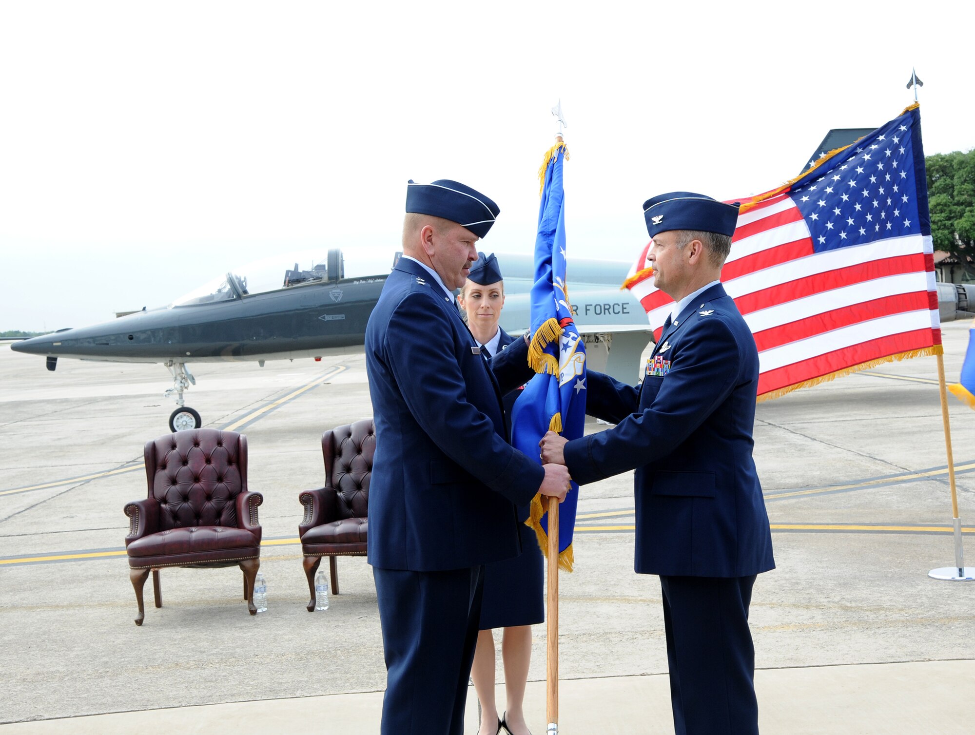 Maj. Gen. Mark A. Kyle, 22nd Air Force commander, passes the unit flag to Col. Brian "Bowwow" Bowman during the 340th Flying Training Group assumption of command ceremony at Joint Base San Antonio-Randolph, Texas, May 2. (U.S. Air Force photo)