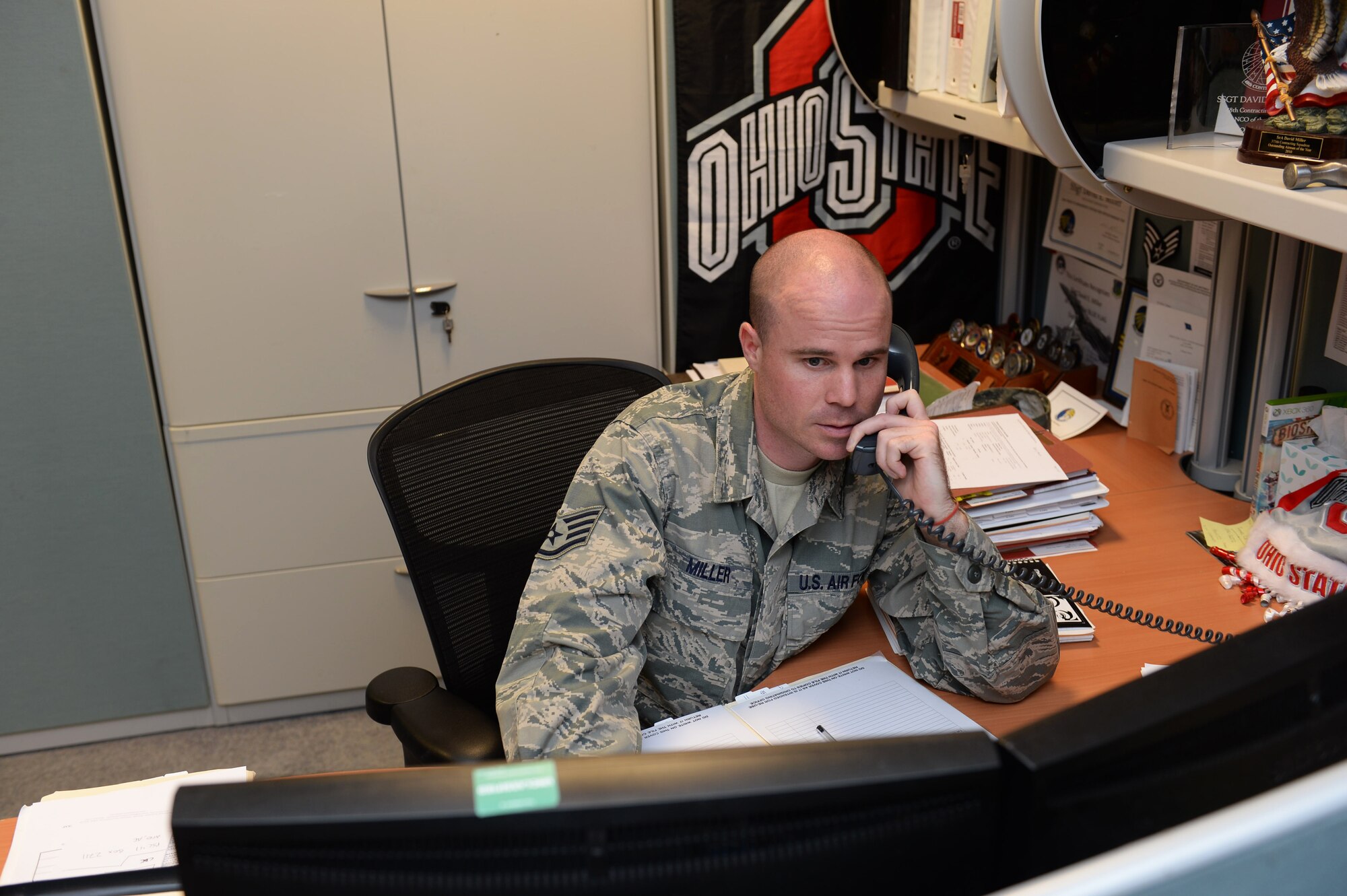 Staff Sgt. David Miller, 48th Contracting Squadron contracting specialist, verifies contract details at Royal Air Force Lakenheath, England, May 28, 2014. Miller was nominated for a Liberty Spotlight because he displays the core value of Excellence in All We Do. (U.S. Air Force photo by Nigel Sandridge/Released)