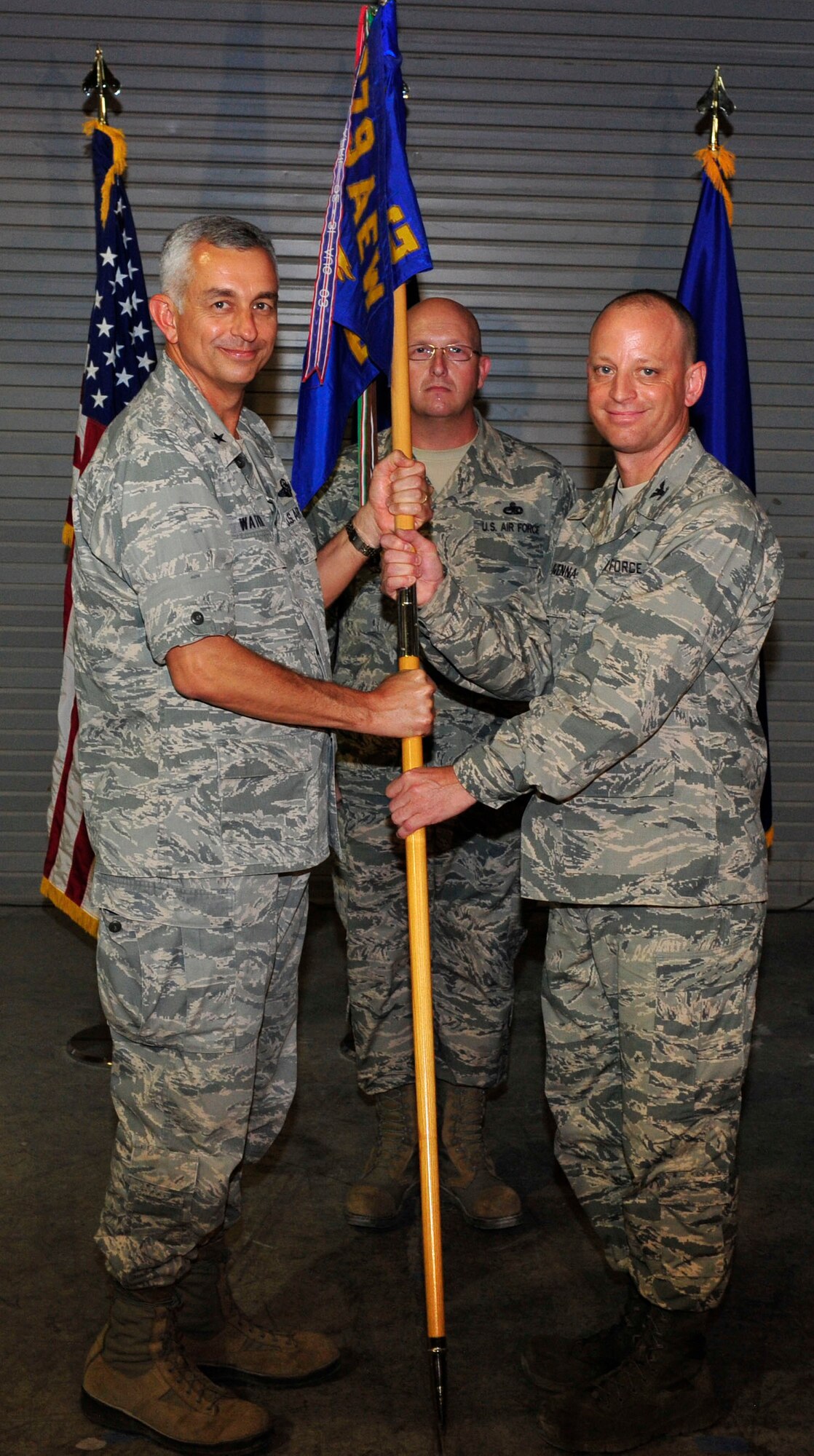 U.S. Air Force Brig. Gen. Roger Watkins 379th Air Expeditionary Wing commander passes the guidon to 379th Expeditionary Maintenance Group commander, Col. James Clavenna, during the change of command ceremony Al Udeid Air Base, Qatar, May 26, 2014. Calvenna is taking over command from Col. Bryan Harris, and is responsible for overseeing maintenance operations at Al Udeid Air Base. Clavenna was the Deputy Director for Logistics and Mission Support at Headquarters Air Force Space Command, Peterson Air Force Base, Colorado, before being assigned at AUAB. (U.S. Air Force photo by Senior Airman Colin Cates)

