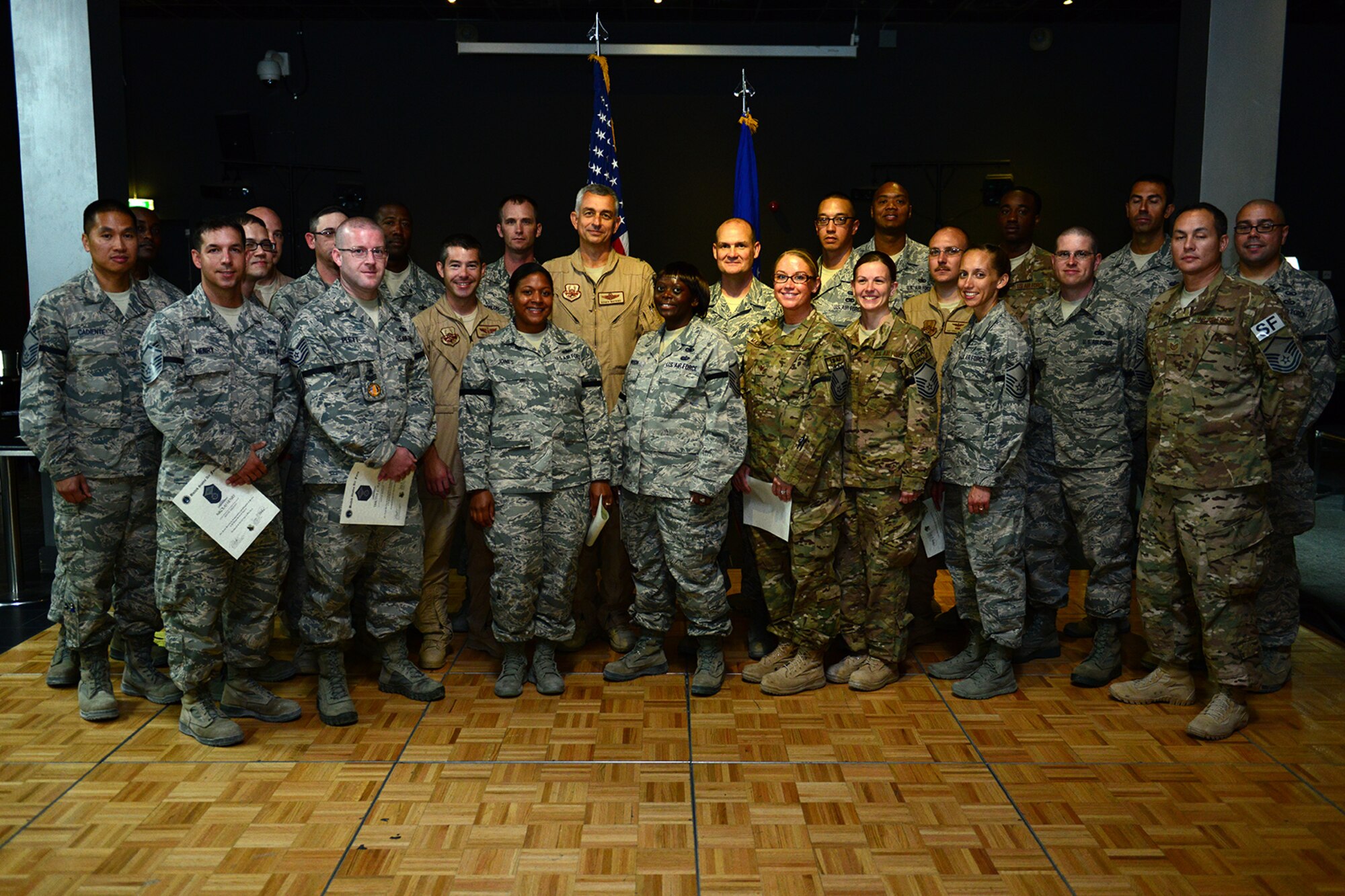 The Grand Slam Wing's newest Master Sgt. selects pose for a group photo with 379th Air Expeditionary Wing leadership at Al Udeid Air Base, Qatar, May 23, 2014. The selects were congratulated by members of the 379th AEW during a celebration. (U.S. Air Force photo by Staff Sgt. Ciara Wymbs)  