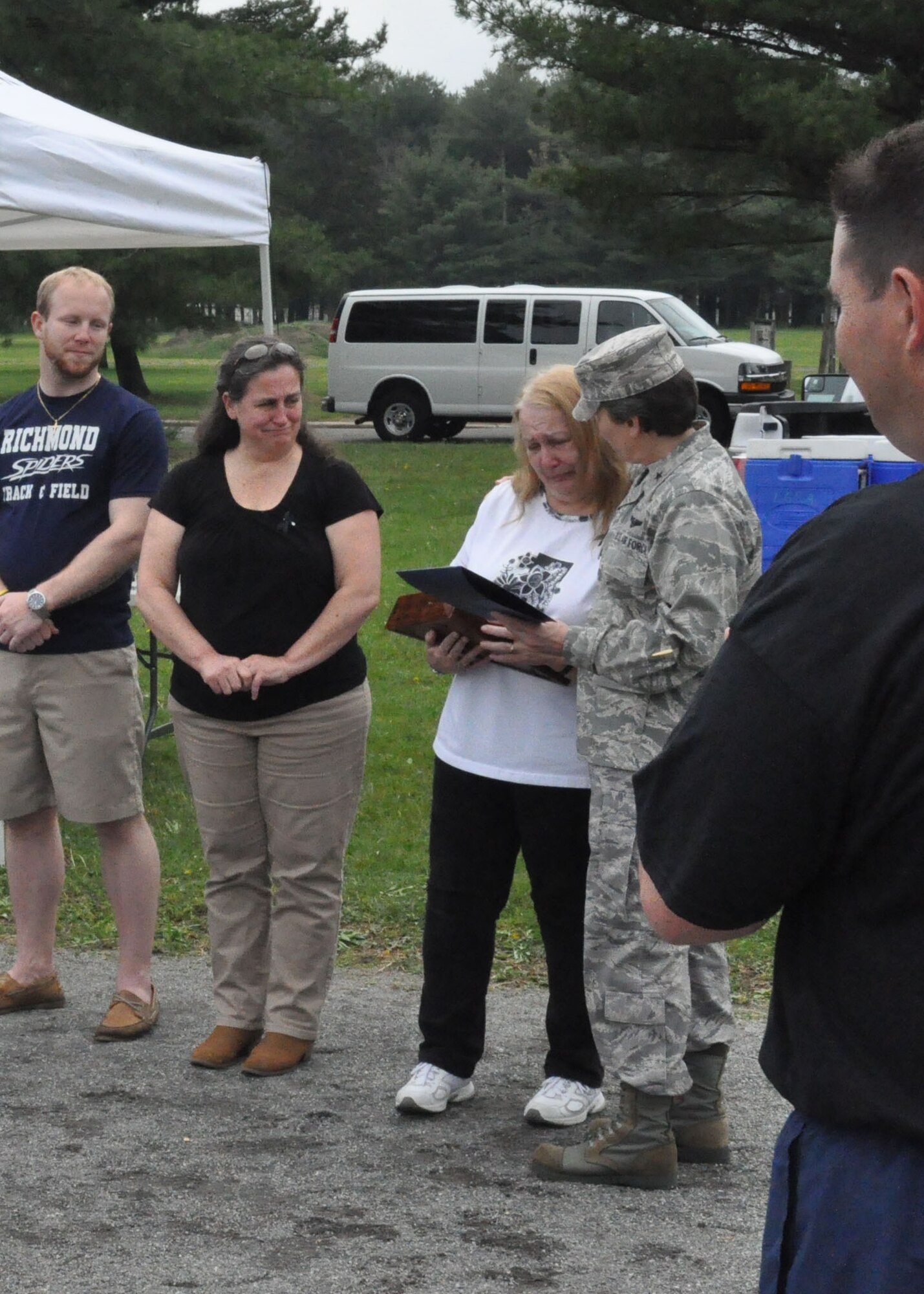 Brig. Gen. Martha Meeker, USAF Expeditionary Center vice commander, presents momentos to Carolann Eccleston, mother of former 621st Contingency Response Wing member TSgt Curtis Eccleston, after the first annual "Port Dawg" memorial run May 22. The career field wide event was held to honor the memory of deceased aerial porters.