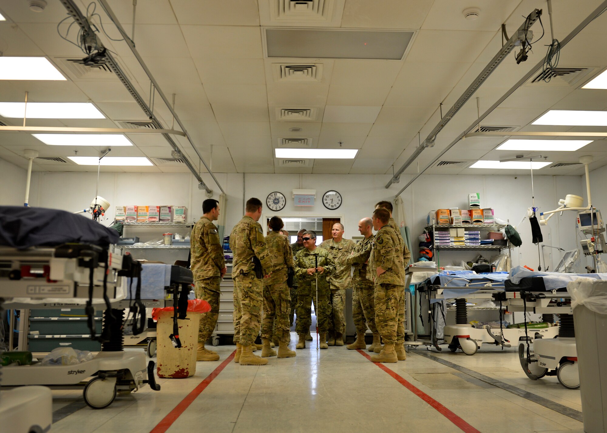 Airmen from Craig Joint Theater Hospital gather around U.S. Army Ret. Sgt. Maj. Colin Rich during Operation Proper Exit at Bagram Airfield, Afghanistan May 28, 2014. Operation Proper Exit is intended to gain a sense of pride and closure for soldiers severely injured in the line of duty. Rich is currently retired a native of New Boston, Mass. (U.S. Air Force photo by Staff Sgt. Evelyn Chavez/Released)