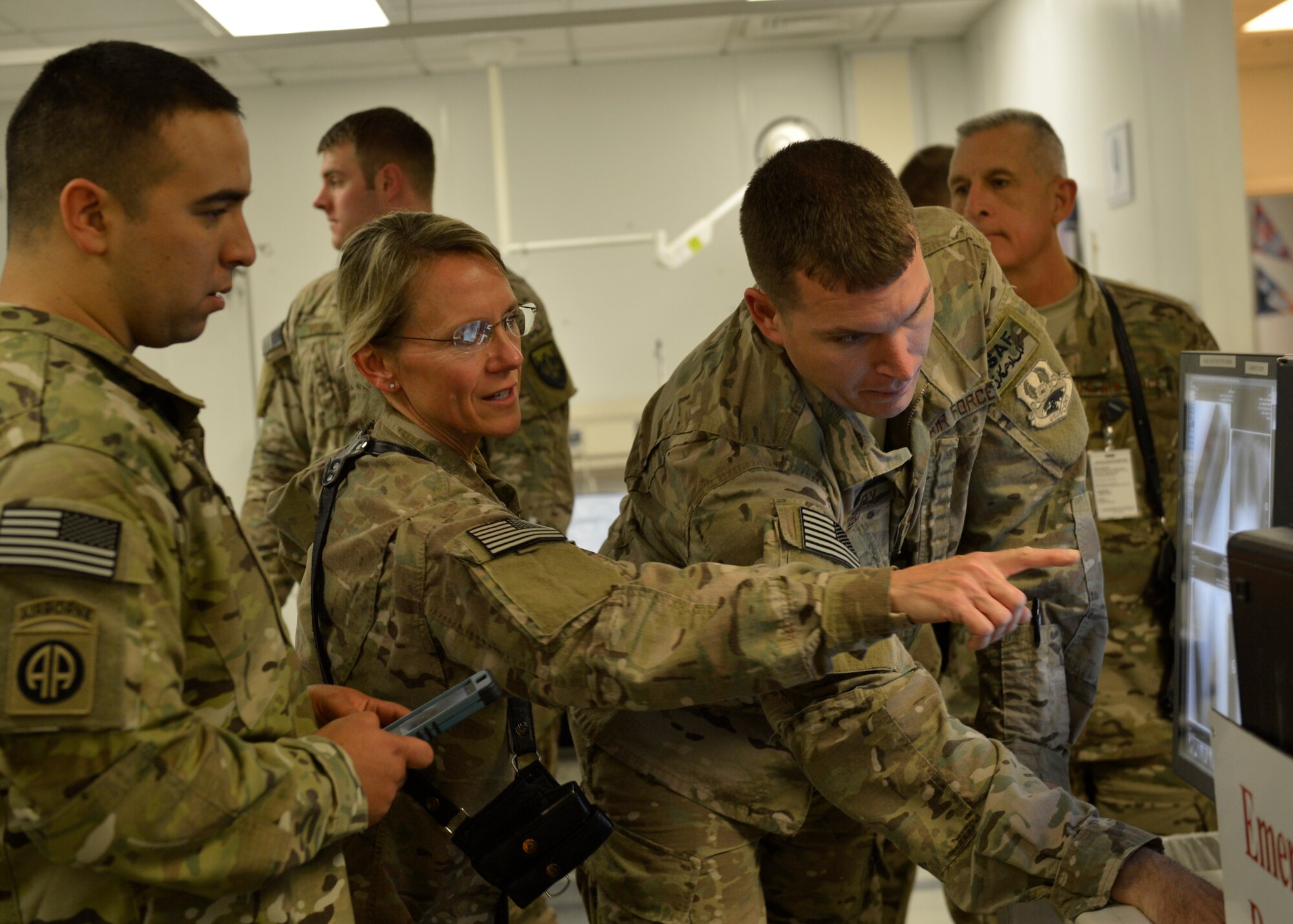 (Left) U.S. Army Sgt. Jose Navarro, reviews his x-rays with medical staff from Craig Joint Theater Hospital during Operation Proper Exit at Bagram Airfield, Afghanistan May 28, 2014.  The program is intended to gain a sense of pride and closure for soldiers severely injured in the line of duty. Navarro talked about his experience and injuries while deployed to Afghanistan.  He is currently retired and a native of Pomona, Calif. (U.S. Air Force photo by Staff Sgt. Evelyn Chavez/Released)
