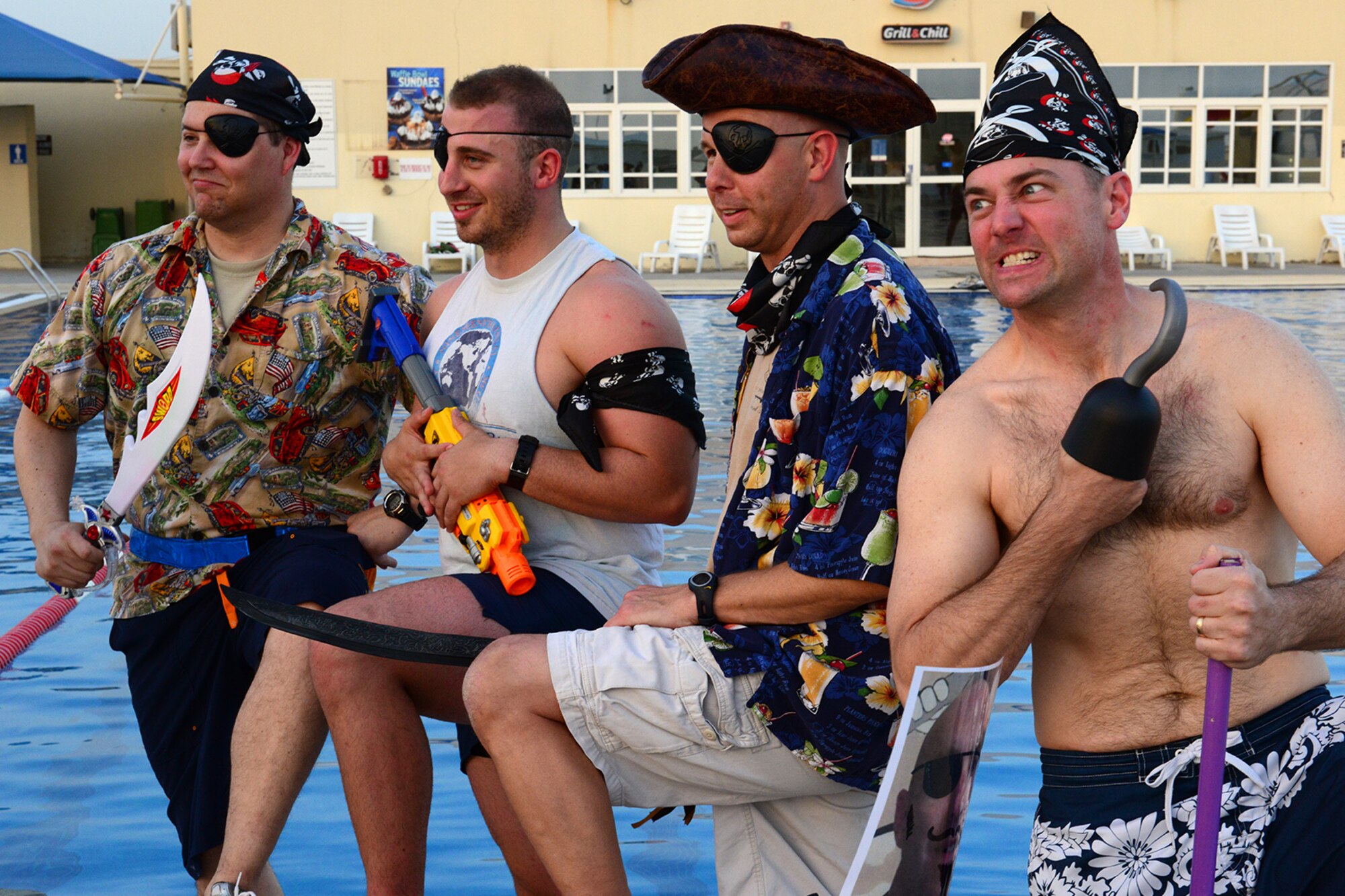 U.S. Air Force Airmen prepare for a cardboard boat regatta at Al Udeid Air Base, Qatar, May 23, 2014. The regatta is a boat race, where teams compete using a boat made of mainly cardboard and tape, to stay afloat. (U.S. Air Force photo by Staff Sgt. Ciara Wymbs)  