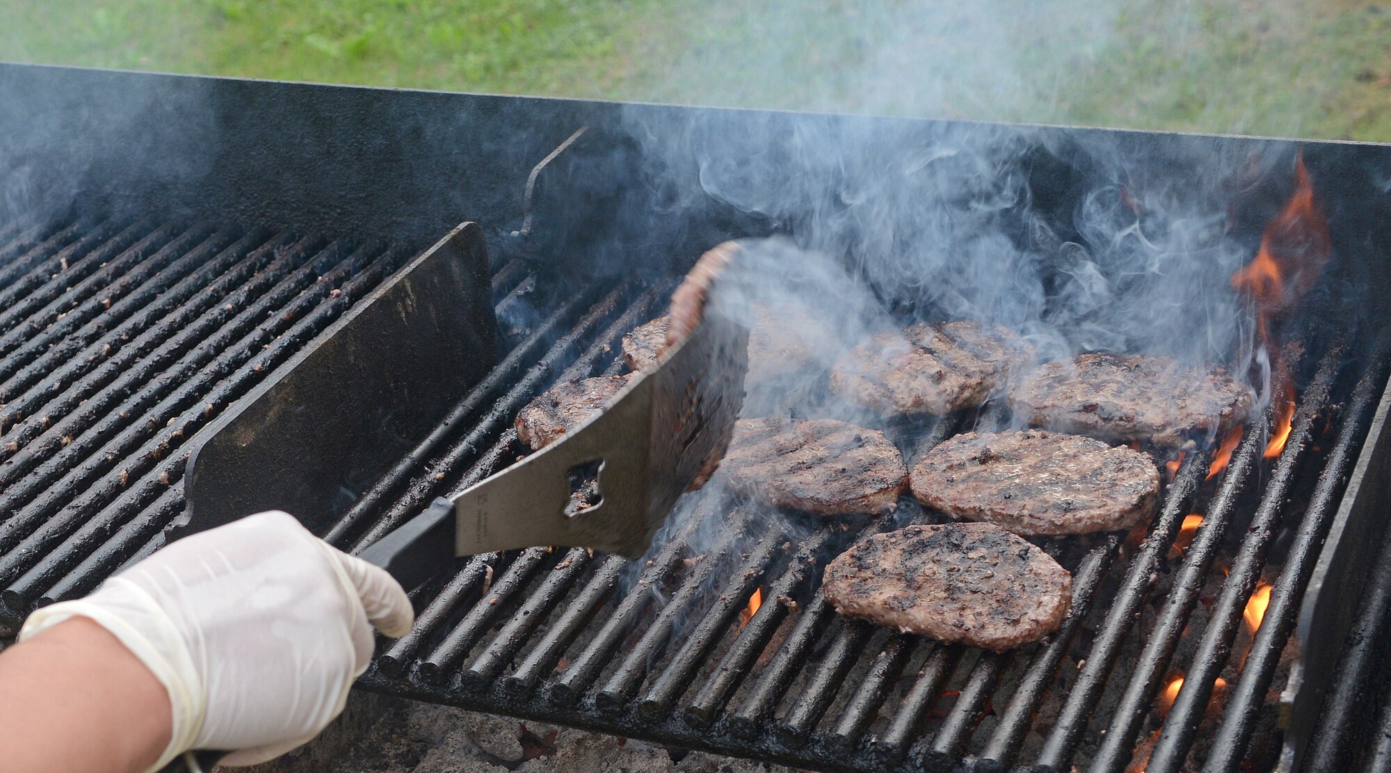 Hamburgers are grilled during a Heart's Apart event, Oct. 15, 2012, at Aviano Air Base, Italy. While outside during the 101 Critical Days of Summer, individuals preparing to grill should heat it up 20 to 30 minutes before cooking. (U.S. Air Force photo/Senior Airman Matthew Lotz)