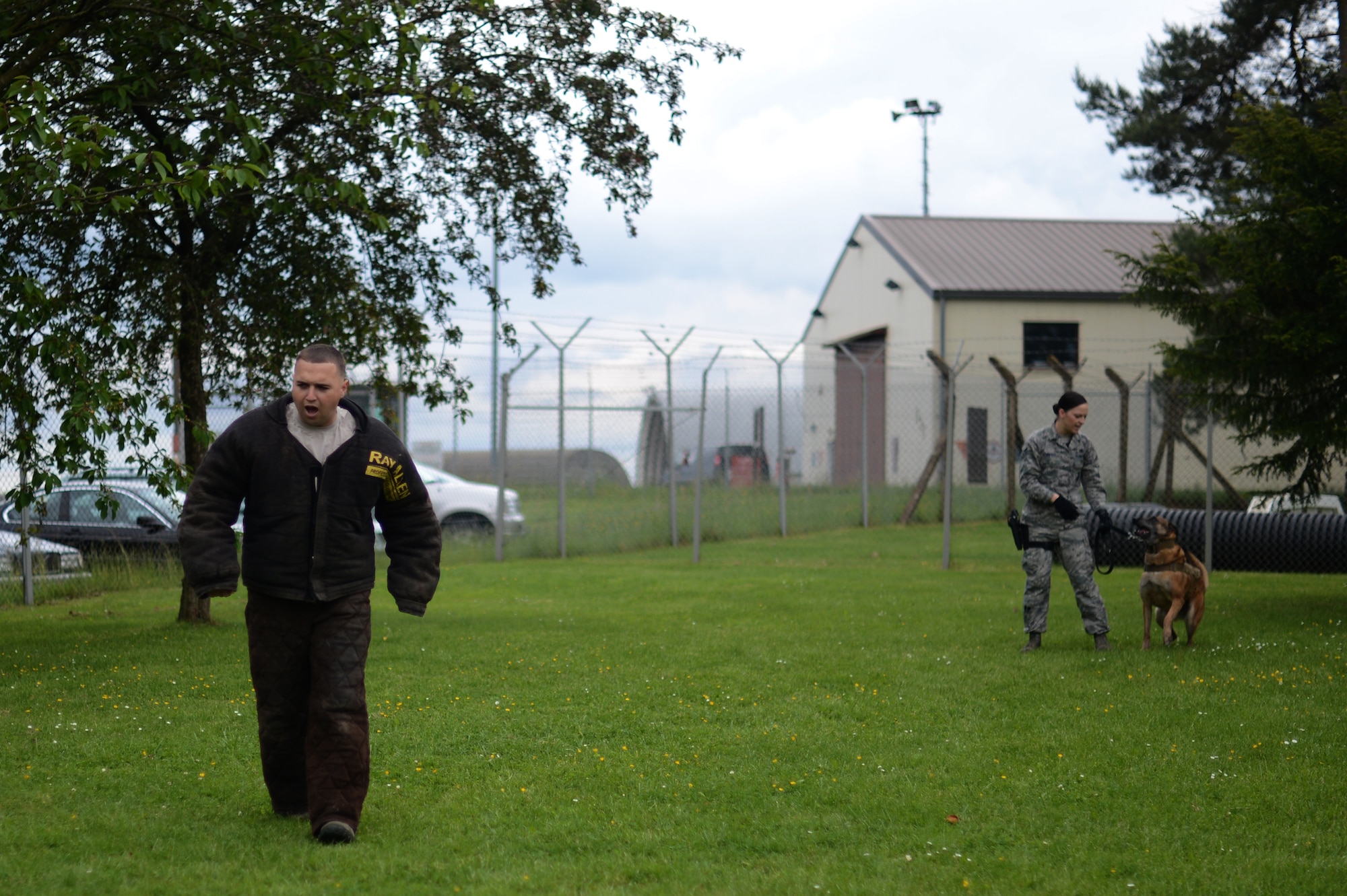 U.S. Air Force Staff Sgt. Roberto Matos, 52nd Security Forces Squadron military working dog trainer supervisor from San German, Puerto Rico, flees from a military working dog handler during a K- 9 demonstration at Spangdahlem Air Base, Germany, May 27, 2014. Dog handlers go through an 8 - week training course at Lackland Air Force Base, Texas, before receiving an assigned dog for real-world operations. (U.S. Air Force photo by Senior Airman Gustavo Castillo/Released)