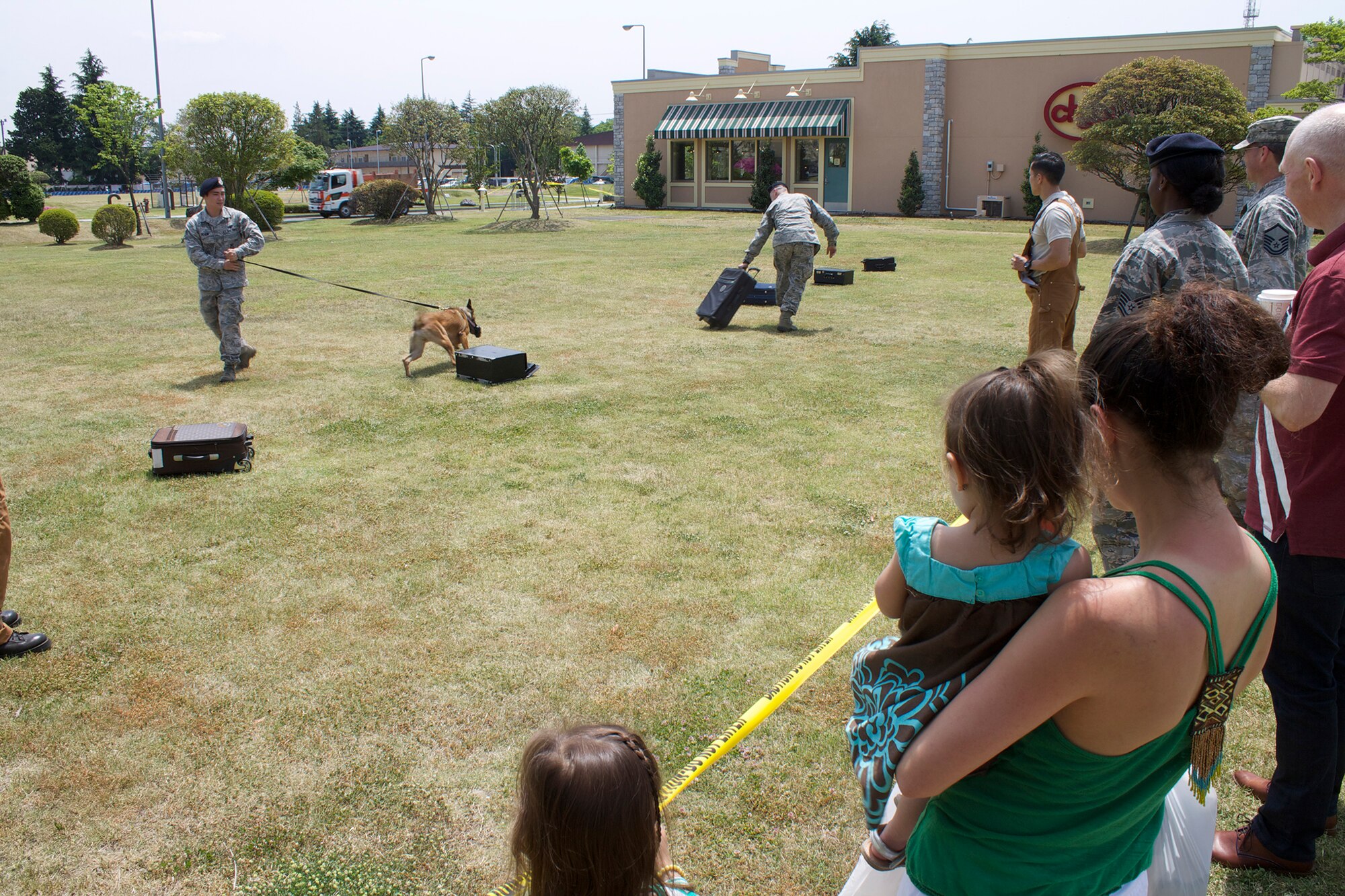 A crowd watches a Military Working Dog demonstration during Police Week at Yokota Air Base, Japan, May 19, 2014. The display was part of Police Week, an event honoring the sacrifices made by local, state and federal law enforcement officers. (U.S. Air Force photo by Airman 1st Class David Danford/Released)
