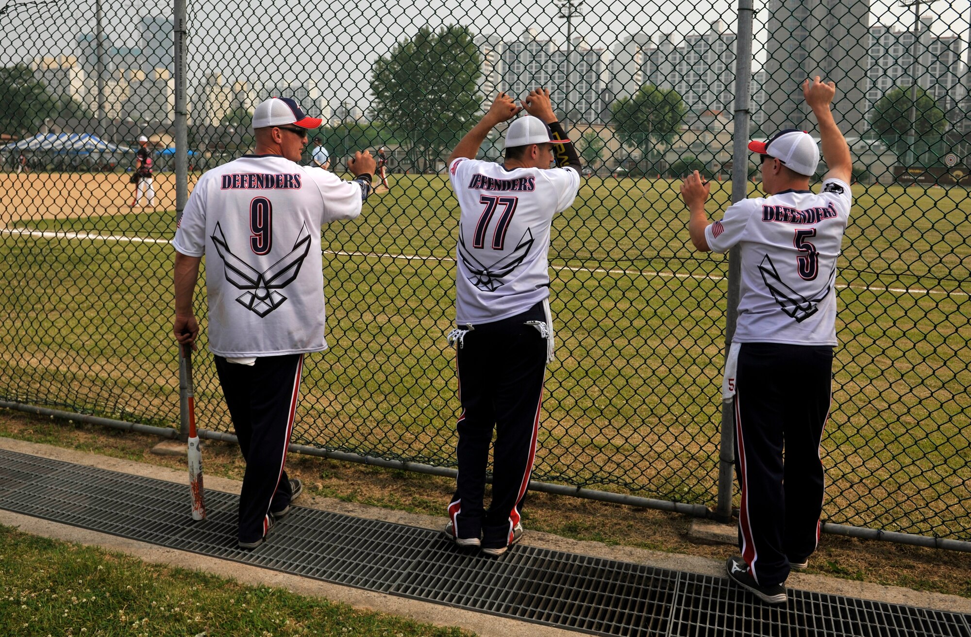 Members of the Osan men’s softball team talk about the current softball game during a round-robin tournament on U.S. Army Garrison Yongsan, Republic of Korea, May 23, 2014. Osan finished in third place in the tournament. (U.S. Air Force photo/Senior Airman David Owsianka)