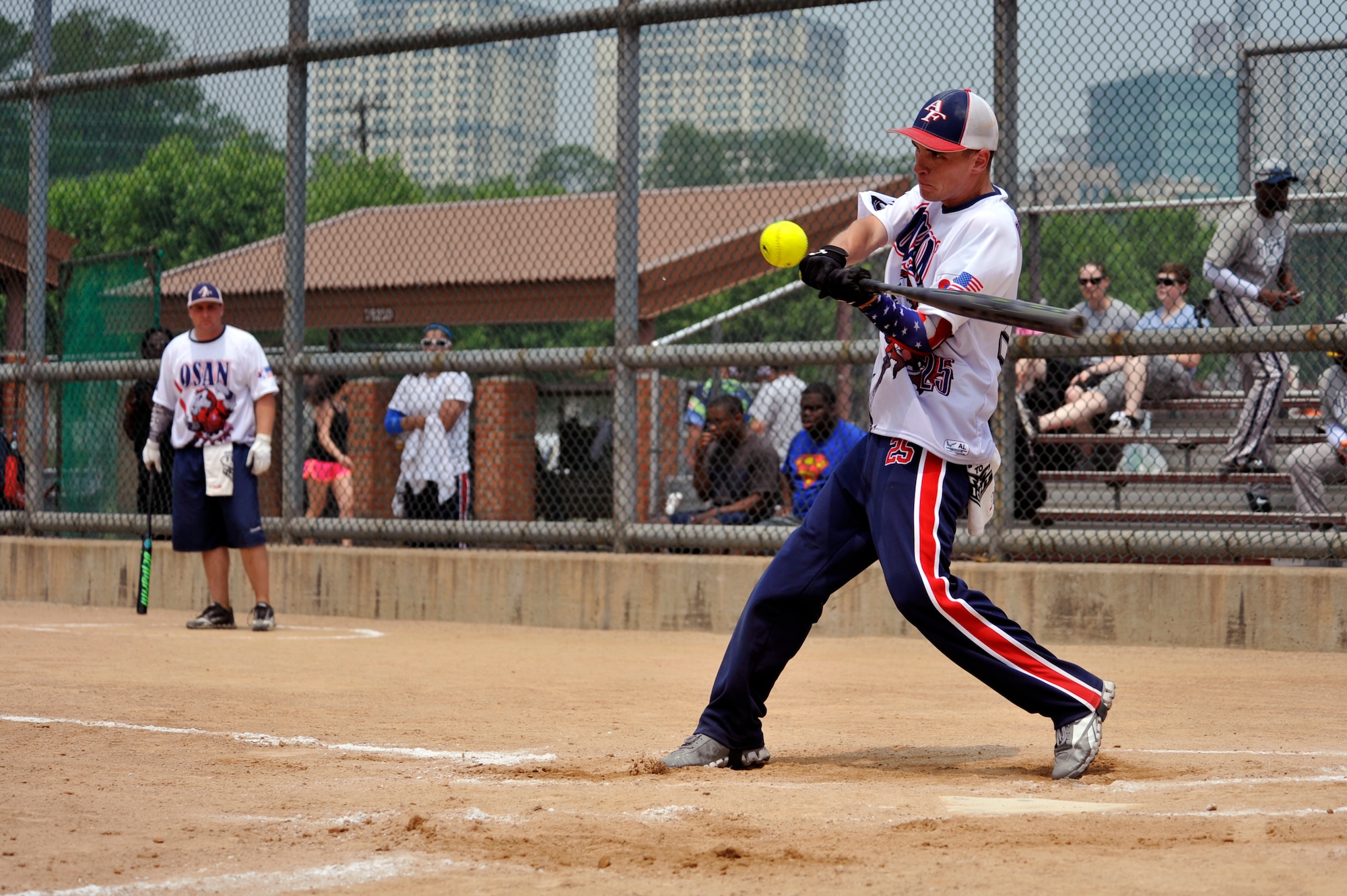 Senior Airman Marc Bergerstock, 51st Civil Engineer Squadron, hits a ball into the outfield during the third inning of the game against the U.S. Army Garrison Daegu team on during a round-robin tournament on USAG Yongsan, Republic of Korea, May 23, 2014. Osan defeated Daegu 19-18. (U.S. Air Force photo/Senior Airman David Owsianka)