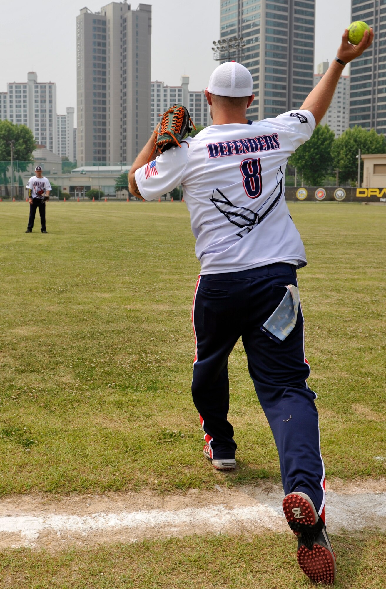 Staff Sgt. Charles Cornacchio, 51st Security Forces Squadron, throws a ball to a teammate as they warm-up before the first game of a round-robin tournament on U.S. Army Garrison Yongsan, Republic of Korea, May 23, 2014. Osan went 6-0 during the round-robin games to become the number one seed in the tournament. (U.S. Air Force photo/Senior Airman David Owsianka)