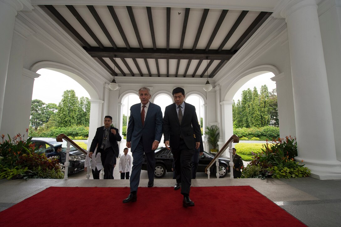 Gabriel Lim, principal private secretary to Singapore’s prime minister, escorts U.S. Defense Secretary Chuck Hagel before a meeting with Singaporean Prime Minister Lee Hsien Loong at the Parliament House in Singapore, May 30, 2014.