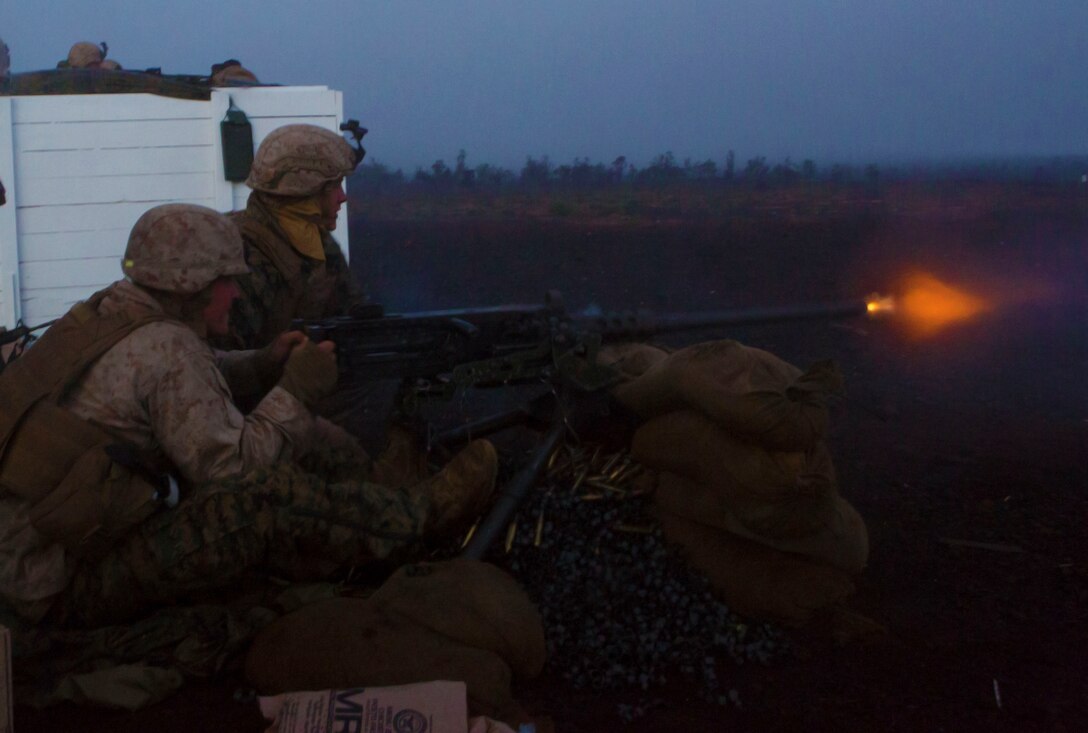 Marines with Weapons Company, 3rd Battalion, 3rd Marine Regiment fire a .50-caliber rifle during a live fire shoot here, May 28. The Marines were being tested on whether they could keep security throughout the night and effectively fire upon targets.