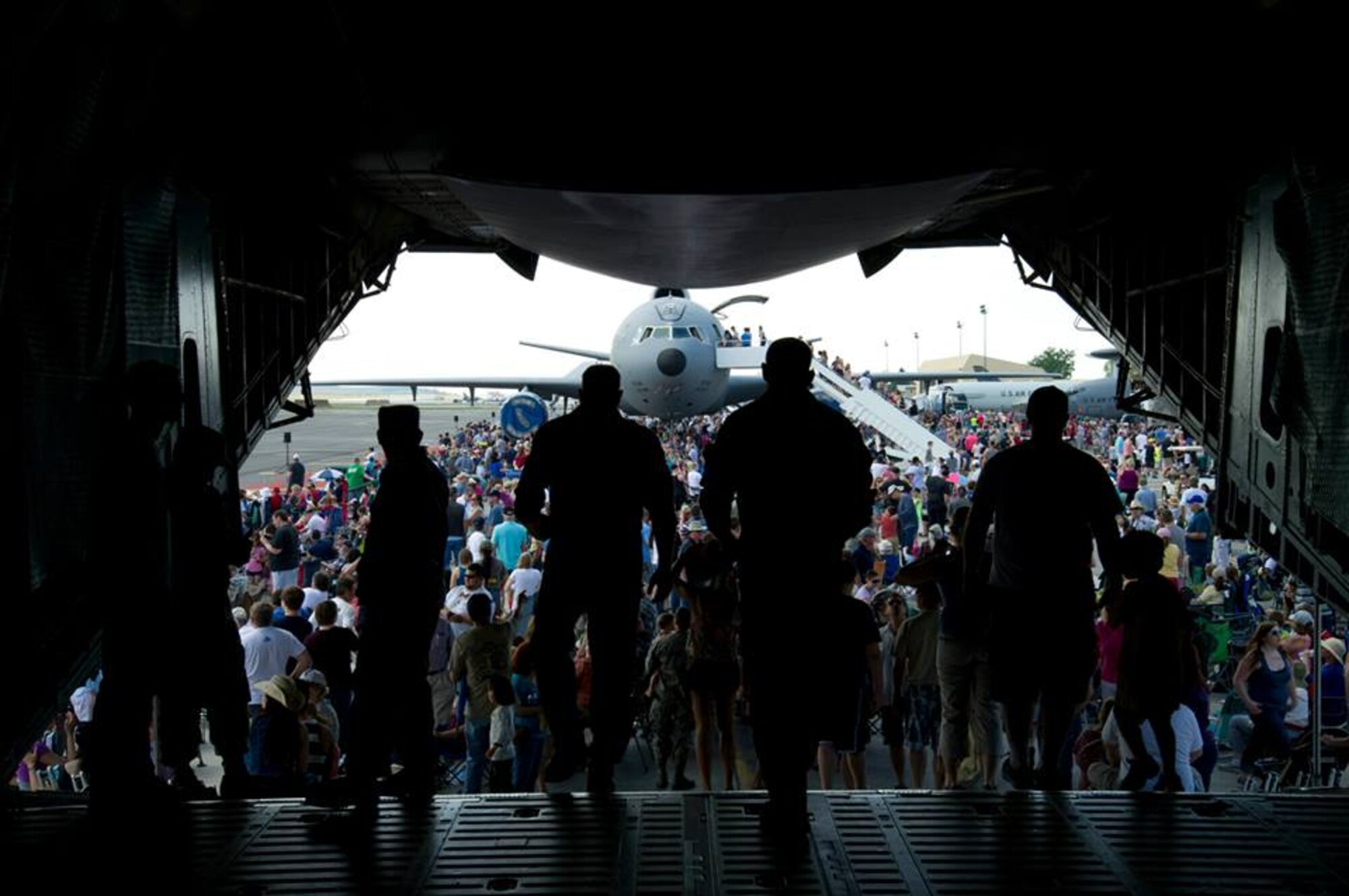 Service members and members from the local community walk off a C-5 Galaxy during SkyFest 2014 at Fairchild Air Force Base, Wash., May 31, 2014. SkyFest 2014 hosted more than 15 types of aircraft and static displays and more than 10 flying performers including the U.S. Air Force Thunderbirds and the U.S. Army Parachute Team, “Golden Knights.” (U.S. Air Force photo by Staff Sgt. Michael Means/Released)