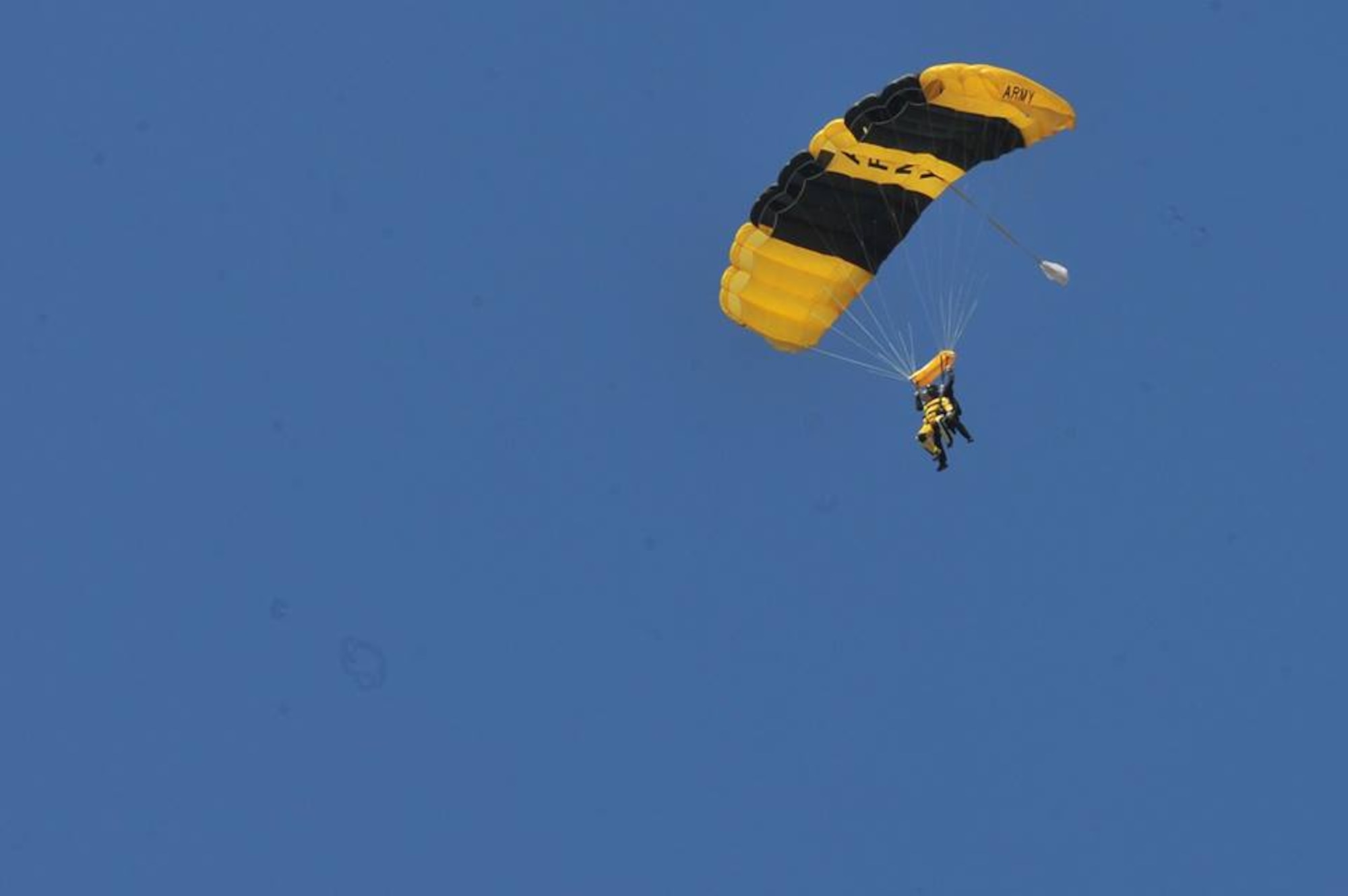 Senior Airman William Forde tandem jumps with the U.S. Army Parachute Team, “Golden Knights”, during SkyFest 2014 at Fairchild Air Force Base, Wash., May 31, 2014. SkyFest is Fairchild’s air show and open house, giving the local and regional community the opportunity to view Airmen and the base’s resources. The event typically draws more than 150,000 people. SkyFest 2008, headlined by the Blue Angels, was the largest event held in Spokane since the 1974 World’s Fair. (U.S. Air Force photo by Staff Sgt. Veronica Montes/Released)