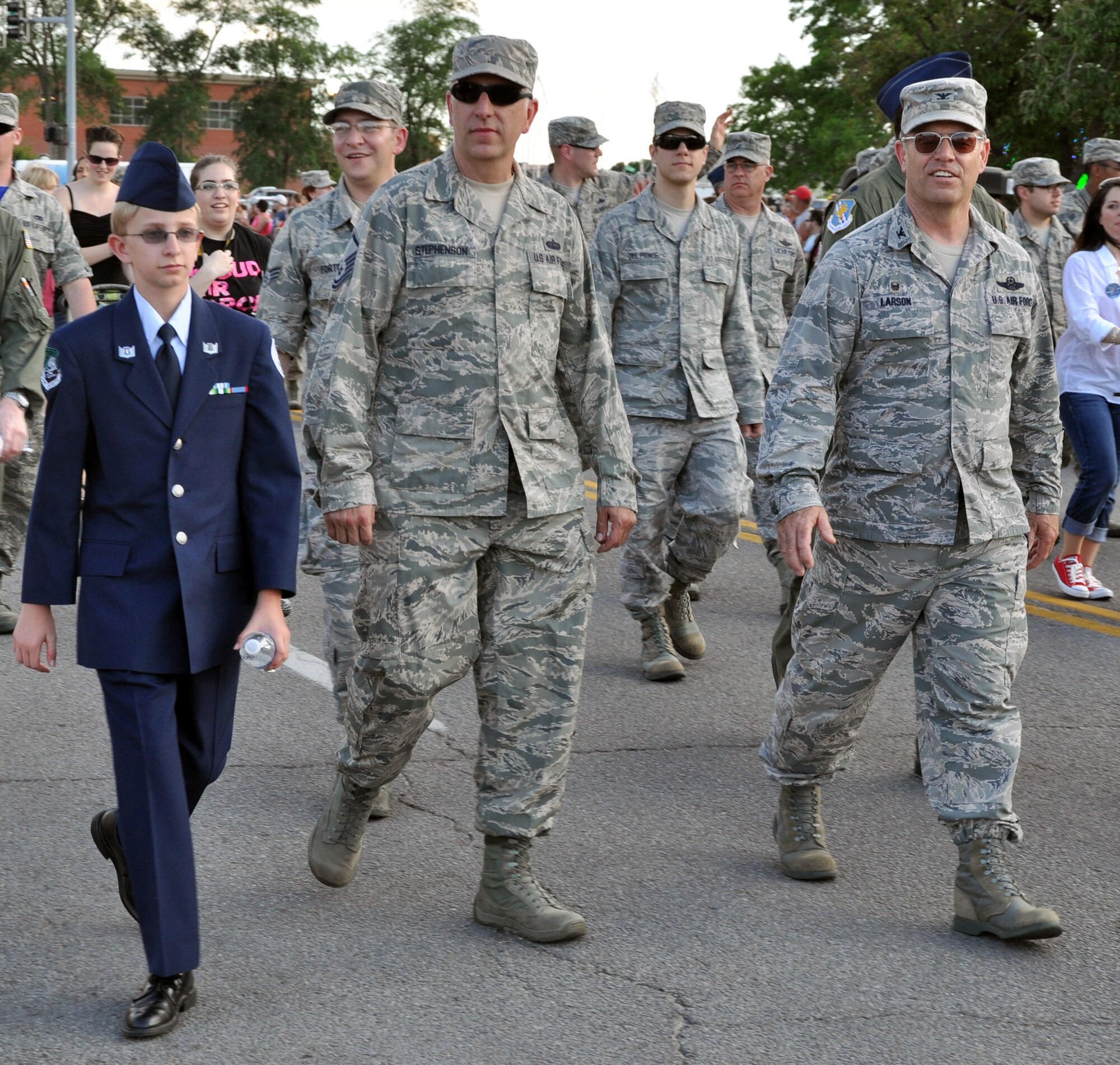 Col. Mark S. Larson, commander, 931st Air Refueling Group, Master Sgt. Johnny Stephenson, 931st Air Refueling Group, and Stephenson's son Taylor, a member of the Derby High School Air Force JROTC, walk in the  Wichita Riverfest "Sundown Parade" in downtown Wichita, Kan., May 30, 2014.  The annual parade marks the kickoff of the week-long community festival. Each year, members of the 22nd Air Refueling Wing, the Air Force Reserve 931st Air Refueling Group, and the Kansas Air National Guard184th Intelligence Wing participate in the parade. (U.S. Air Force photo by Capt. Zach Anderson)