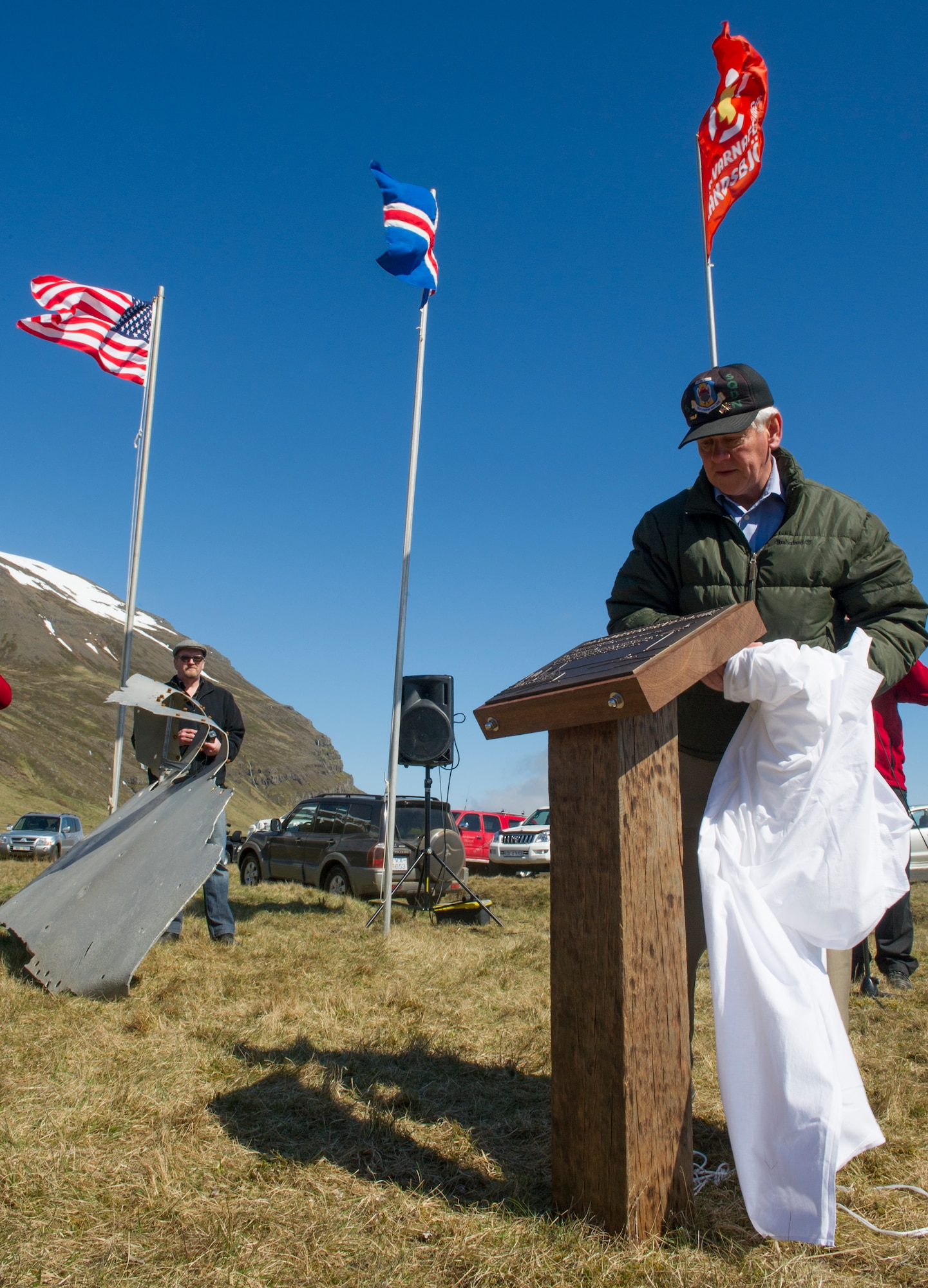 VODLAVIK, Iceland -- Retired Col. Gary Copsey unveils a plaque during a ceremony May 30, 2014, commemorating a rescue mission on the coastline of Vodlavik, Iceland. During the mission, U.S. Airmen saved the lives of six Icelanders stranded aboard their ship, the Godinn. (U.S. Air Force photo/Tech. Sgt. Benjamin Wilson)(Released) 
