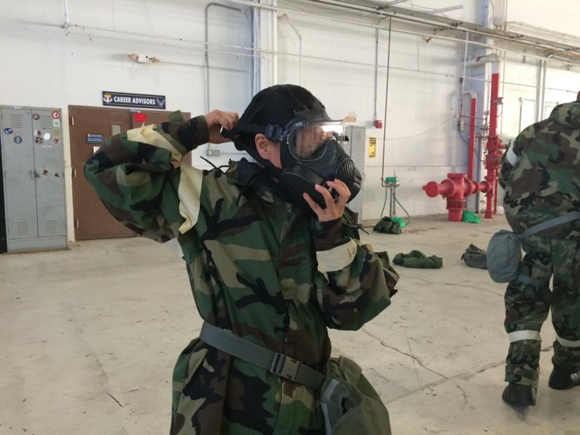 Reservists with the 920th Rescue Wing, Patrick Air Force Base, Fla., were giving refresher training on filtering through a decontamination line and properly donning a gas mask during their unit training assembly November 1, 2014. (U.S. Air Force photo/Maj. Cathleen Snow)