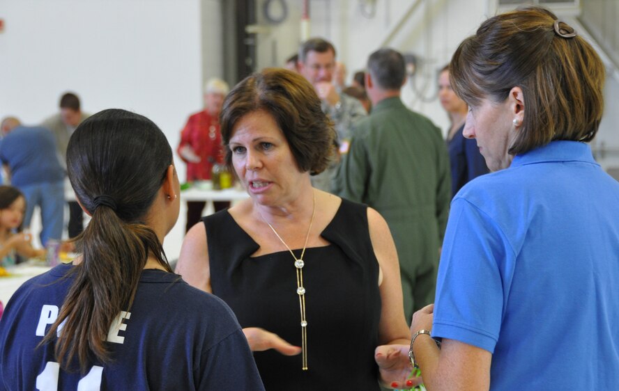 Elizabeth Jones, 302nd Airlift Wing Key Spouse coordinator talks with spouses during the wing's sponsored Deployed Family Dinner on Sept. 19.  Jones and her husband, Col. Kurt Jones, 302nd Operations Group commander will leave the 302nd Airlift Wing in November for his new assignment at Headquarters Air Force Reserve Command.  With her departure from the 302nd AW, Jones is hopeful more spouses will consider taking on an active role in the reserve wing's Key Spouse program. (U.S. Air Force photo/Master Sgt. Daniel Butterfield) 