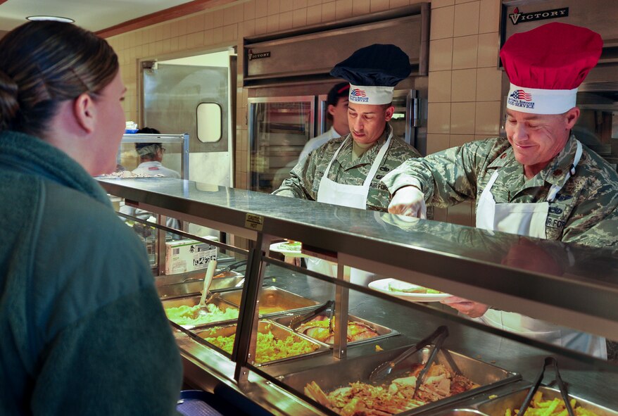 Majors Ed Torres and Jeff Powell, 919th Maintenance Group, fix a lunch plate for Airmen during the annual holiday meal at Duke Field Fla., Nov. 1.  919th Special Operations Wing leadership served food for the Airmen during the meal.  (U.S. Air Force photo/Dan Neely)