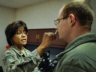 Maj. Francine Ricks, a nurse with the 919th Special Operations Medical Squadron, sprays the flu mist vaccine into an Airman’s nose at Duke Field, Fla., Nov. 1.  More than 600 doses of the vaccine were administered during the November unit training assembly.  (U.S. Air Force photo/Dan Neely)