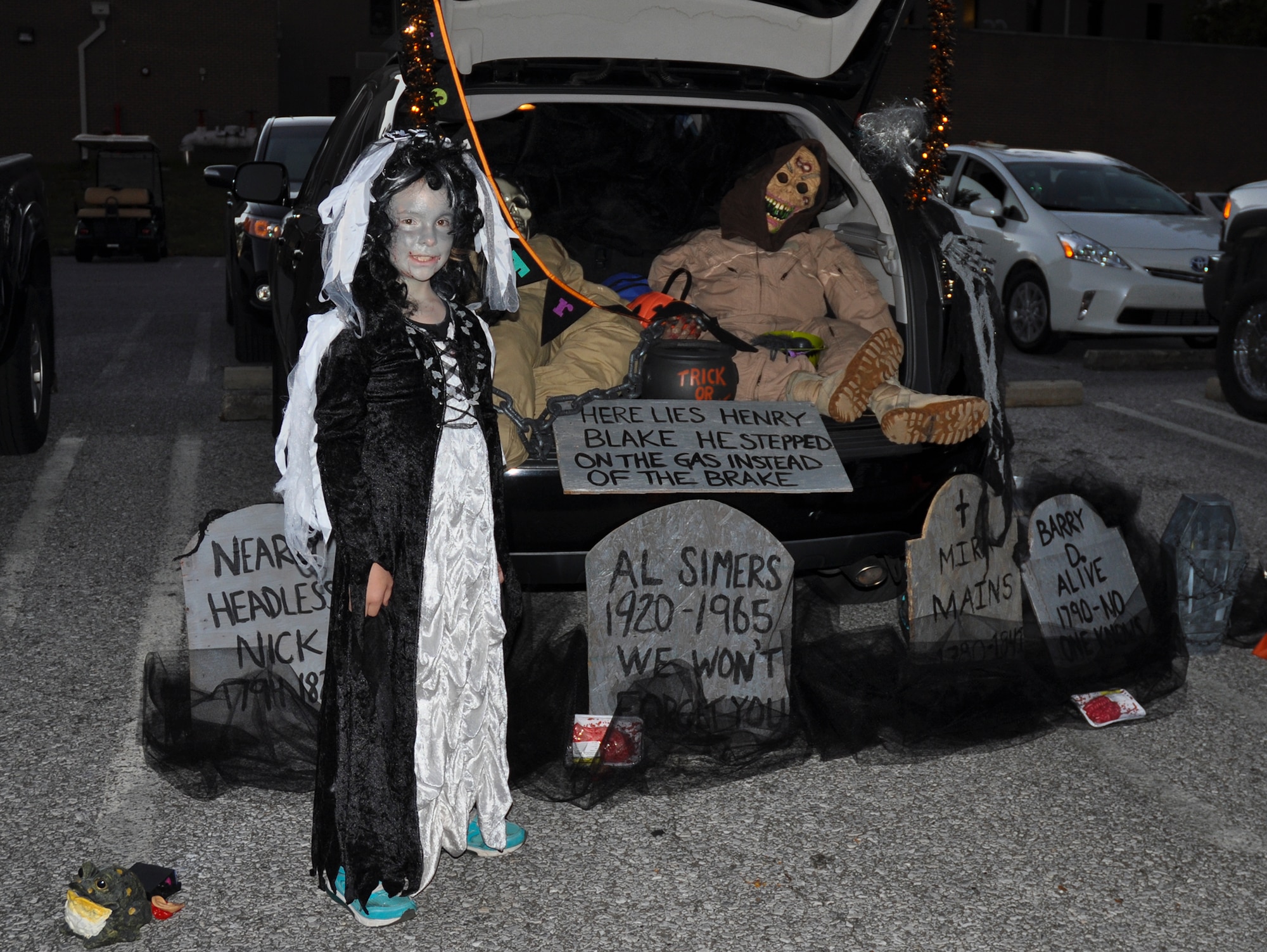 A witch stands next her graveyard car during the 919th Special Operations Wing’s “Trunk of Treat” event Oct. 30 at Duke Field, Fla.  More than 100 costumed kids and parents turned out to give and receive candy and goodies.  Trophies were also passed out to the best decorated vehicles.   (U.S. Air Force photo/Dan Neely)   