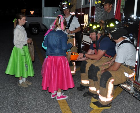 The members of the 919th Special Operations Wing fire department pass out candy at the wing’s “Trunk of Treat” Oct. 30 at Duke Field, Fla.  More than 100 costumed kids and parents turned out to give and receive candy and goodies.  Trophies were also passed out to the best decorated vehicles.   (U.S. Air Force photo/Dan Neely)