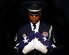 Master Sgt. Andre Moore clutches an American Flag to his chest during a studio portrait Oct. 28, 2014, at Aviano Air base, Italy. Moore served with the U.S. Air Force Honor Guard for more than four years and uses his knowledge to develop Airmen at the base honor guard level. Moor is the Aviano Base Honor Guard superintendent. (U.S. Air Force photo/Airman 1st Class Ryan Conroy)