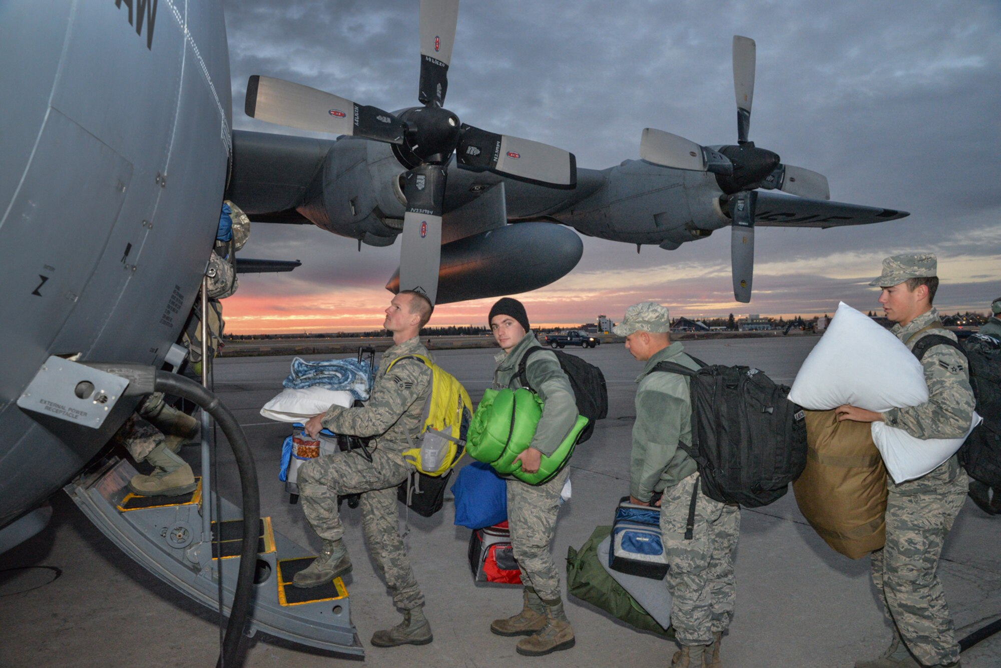 U.S. Air Force Airmen from the 153rd Airlift Wing, Wyoming Air National Guard board a C-130H Hercules aircraft. Maintenance, Operations, and Logistics airmen deploy in support of the Overseas Contingency Operations in Southwest Asia. The Wyoming Air National Guard Airmen and aircraft are relieving members of the 130th Airlift Wing, Charleston West Virginia. (U.S. Air National Guard photo by Master Sgt. Charles Delano/released)