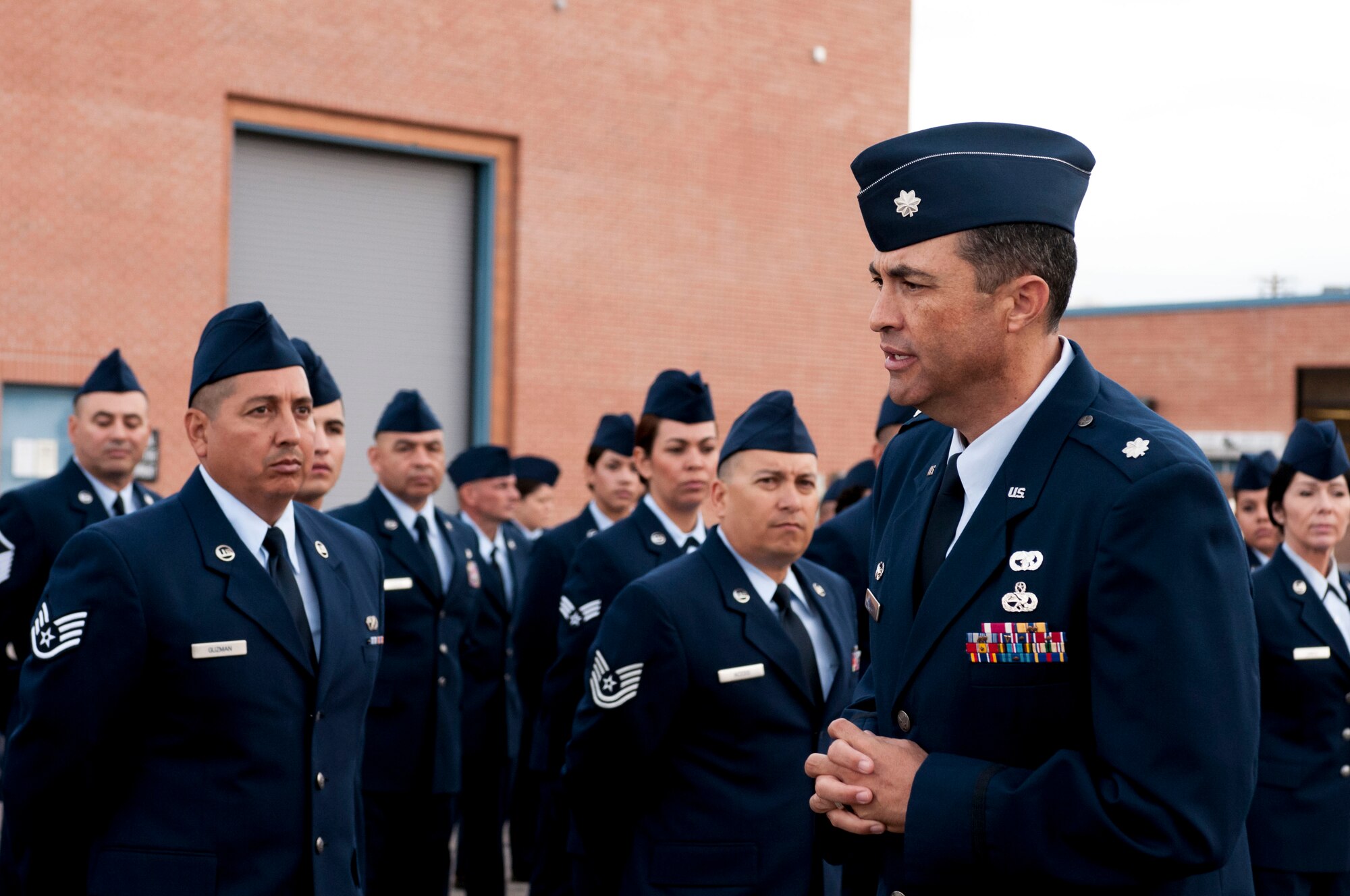 Lt. Col. Fausto Padilla, 162nd Logistics Readiness Squadron commander, confers with Airmen after a successful open ranks inspection on Nov. 2 at the Tucson International Airport. More than 70 Airmen assembled near building 6 in their dress blues, where Senior Master Sgt. Daniel Ramirez inspected the crew for hygiene and uniform appearance while ensuring their medals and uniforms were in line with military personnel flight records. (U.S. Air National Guard photo by Tech. Sgt. Hollie A. Hansen/Released)