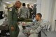 Maj. Victor Vargas, a 920th Aeromedical Staging Squadron, Patrick Air Force Base, Fla., flight surgeon, asses Senior Airman Jose Colon, 920th ASTS medic,  during a squadron-wide patient transport training exercise November 2, 2014. Reservists within the squadron simulated transporting patients from a simulated emergency room atmosphere to a HC-130P/N King aircraft for transport. (U.S. Air Force photo/Senior Airman Natasha Dowridge)