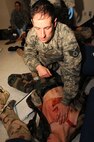 Staff Sgt. Michael Lydon of the 111th Medical Group provides care to a mock victim during a simulated mass casualty event Nov. 2, 2014, at the medical group building on Horsham Air National Guard Station, Pa. Members of the wing’s student flight took on the roles of the victims during the exercise. (U.S. Air National Guard photo by Tech. Sgt. Andria J. Allmond/Released)