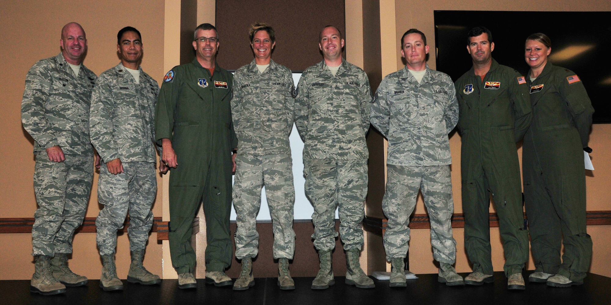 (From Left) Lt. Col. Hoyt Slocum, 161st Air Refueling Wing inspection team chief; Maj. Gilbert Besana, 161st Aircraft Maintenance Squadron commander; Lt. Col Jim Gloss, 197th Air Refueling Squadron commander; Tech. Sgt. Bethany Skaritka, 161st Maintenance Group crew chief; Staff Sgt. Chris Hostetler, 161st Maintenance Group crew chief; Staff Sgt. Nick Savasta, 161st Maintenance Group crew chief; Capt. John Smith, 161st Operations Group pilot; Maj. Tami Demik, 161st Air Refueling Wing safety officer. Maintenance leadership and aircrew present the 161st safety award to these crew chiefs for “outstanding action”, Phoenix, Nov. 2, 2014. “The working relationship between Maintenance and Operations is integral to successful mission accomplishment, both during home station training and global operations,” said Maj. Tami Demik, 161st Air Refueling Wing safety officer. “Maintaining a positive and proactive safety culture, and employing accurate risk management techniques, allow the 161st Air Refueling Wing to deliver 100% mission effectiveness.” (U.S. Air National Guard Photo by Tech. Sgt. Courtney Enos/Released)