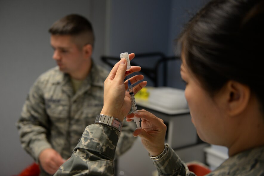 Senior Airman Xiaoliang Verhault prepares a flu shot during an annual Point of Dispensing exercise on Nov. 1, 2014 at Pease Air National Guard Base, N.H.  The exercise tests the group’s ability to provide immunizations to wing personnel.  Verhault is assigned to the 157th Medical Group at Pease. (U.S. Air National Guard photo by Staff Sgt. Curtis J. Lenz)