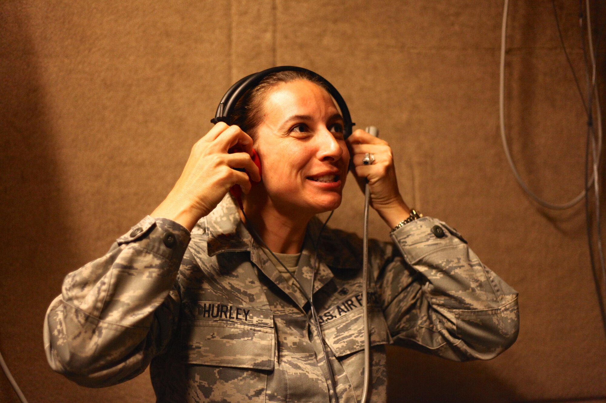 Maj. Nicole Hurley, the 315th Aerospace Medicine Squadron officer in charge of occupational health, dons her headset just before taking a hearing test Saturday Nov. 1, 2014, in the hearing booth at the aerospace medicine office here at Joint Base Charleston, South Carolina. (U.S. Air Force photo by Staff Sgt. Rashard Coaxum)