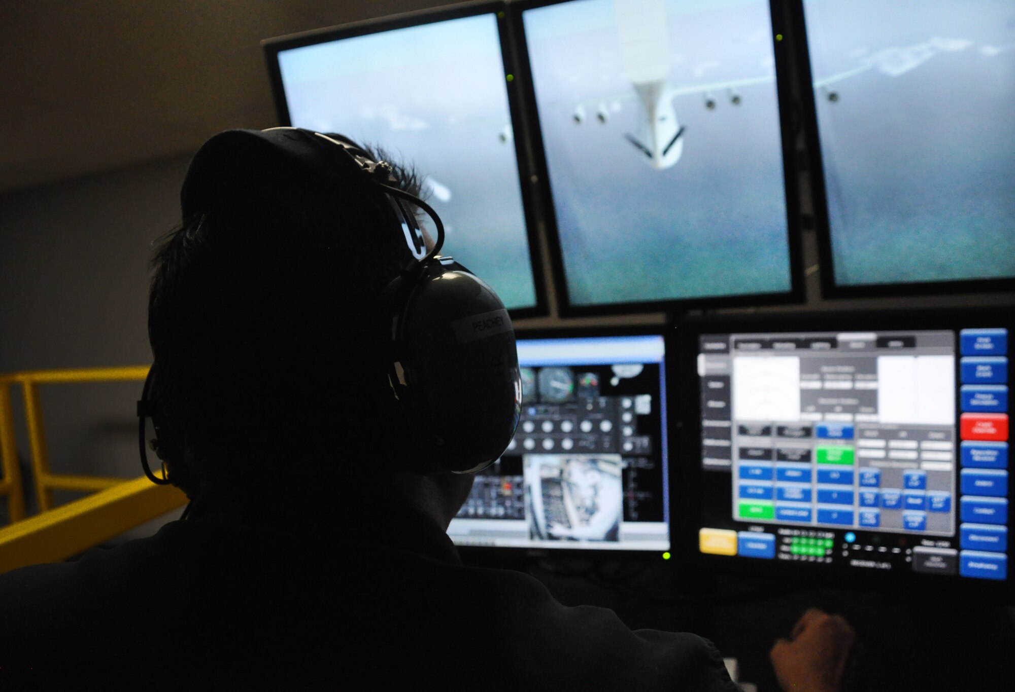 A boom operations weapons system trainer instructor monitors a computer screen during a simulated refueling mission Nov 1, 2014 at MacDill Air Force Base, Florida. This specific scenario tested the boom operators ability to refuel a C-5 Galaxy in a simulated real world environment.(U.S. Air Force photo/Senior Airman Xavier Lockley)